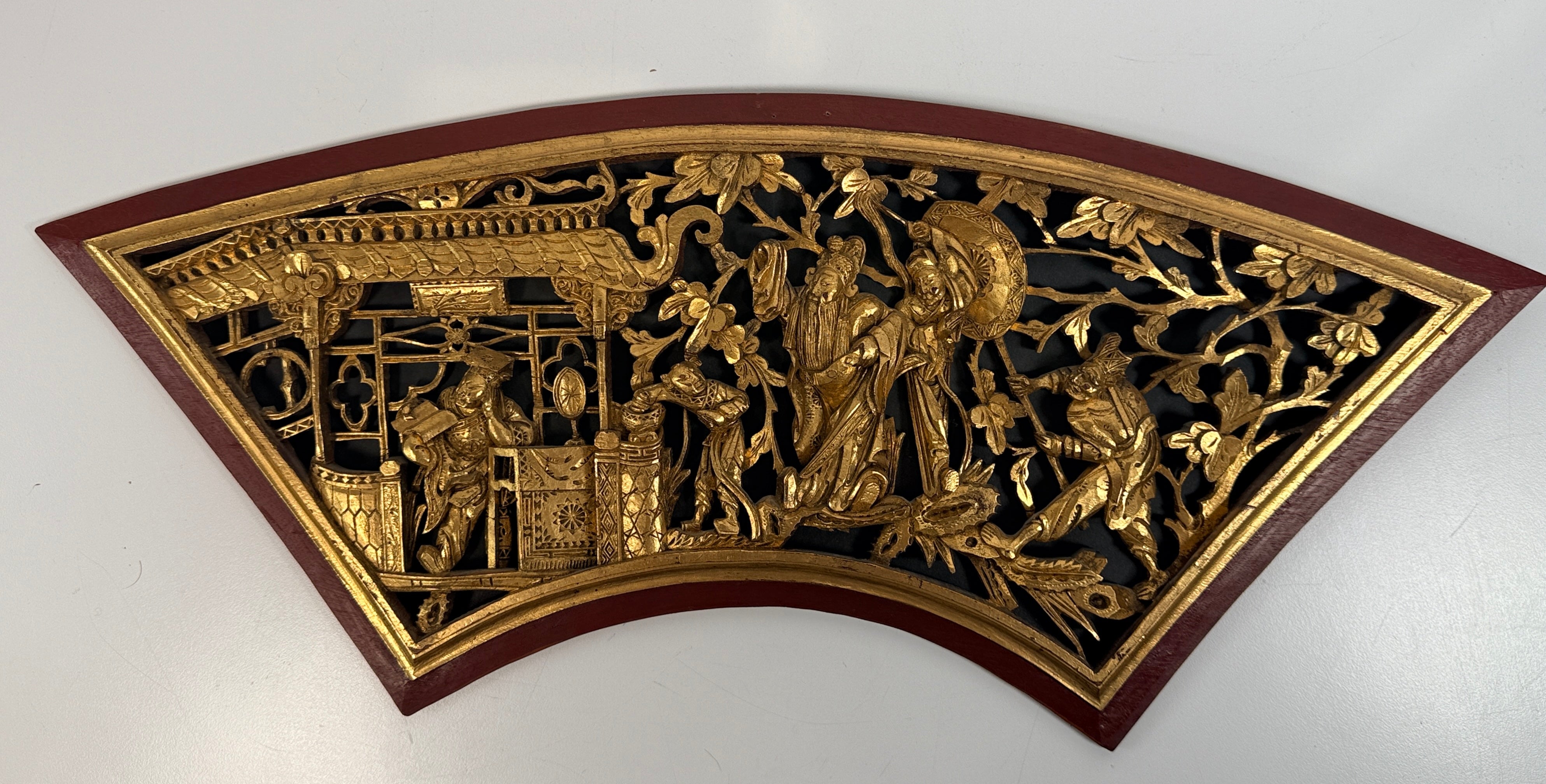 Vintage Chinese carved gilt wood wall panel in fan shape, detailed figural scene, mid-century Chinoiserie décor, openwork carving statement piece.