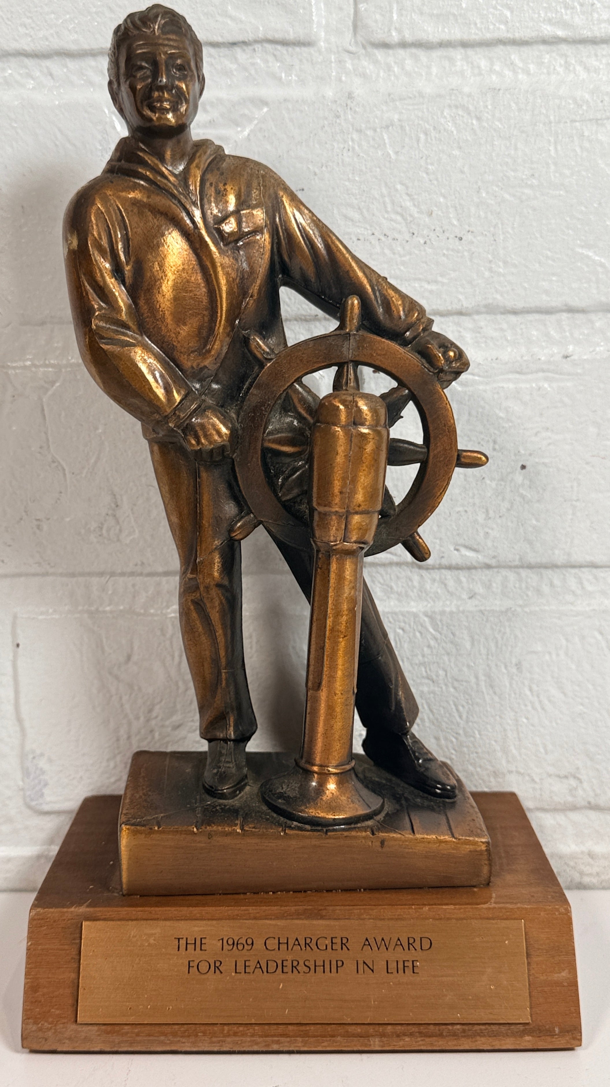 Vintage 1969 sailor helm award statue with bronze finish on wood base. Nautical décor piece with plaque, ideal for maritime collectors or mid-century display