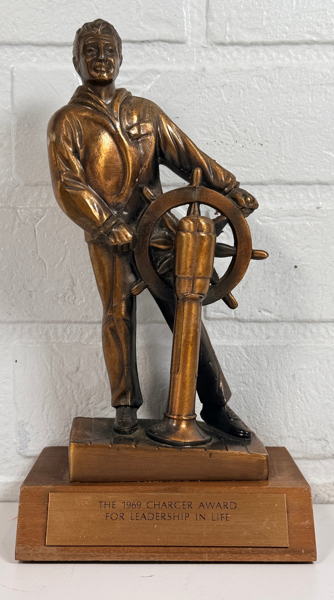 Vintage 1969 sailor helm award statue with bronze finish on wood base. Nautical décor piece with plaque, ideal for maritime collectors or mid-century display
