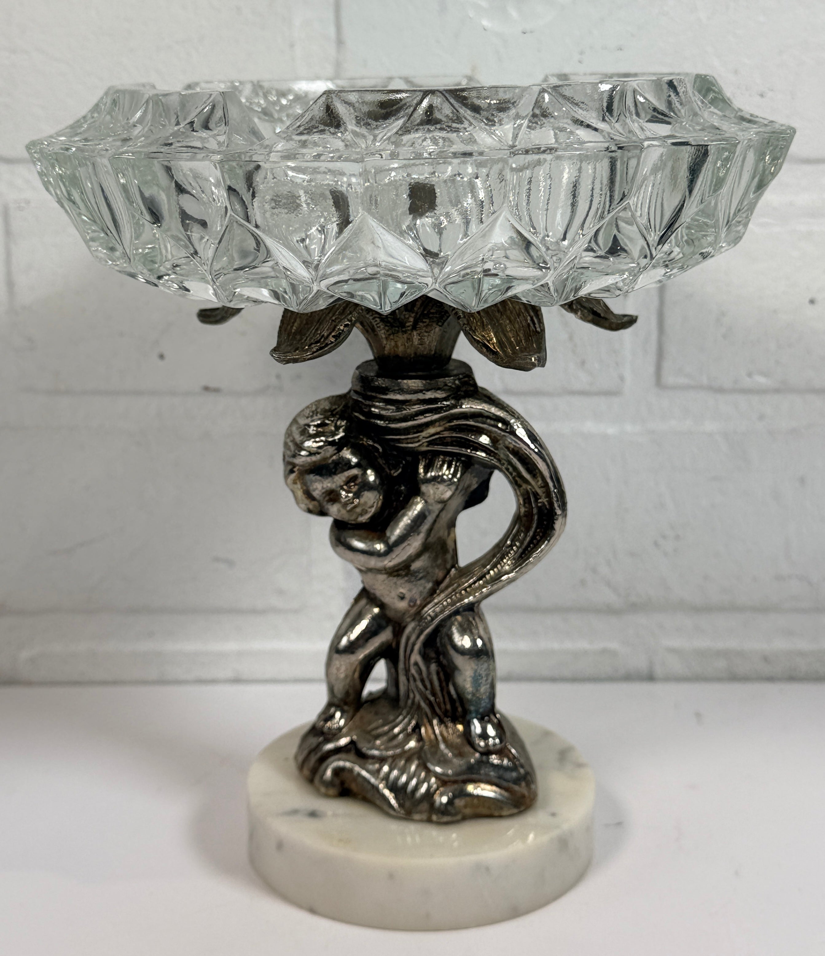 Vintage Hollywood Regency cherub pedestal dish with glass bowl and marble base. Elegant mid-century décor perfect for trinkets, candy, or display.