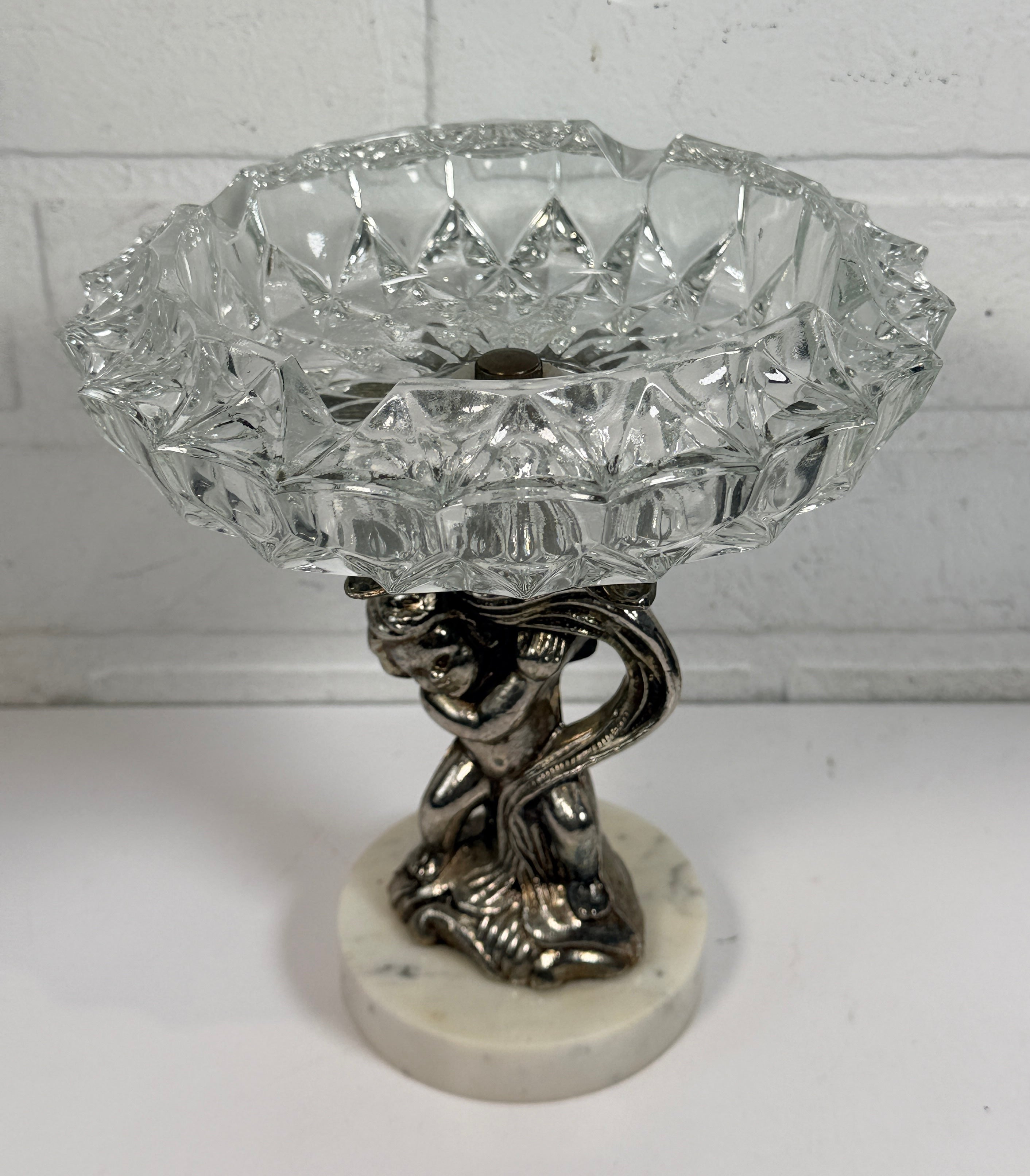 Vintage Hollywood Regency cherub pedestal dish with glass bowl and marble base. Elegant mid-century décor perfect for trinkets, candy, or display.