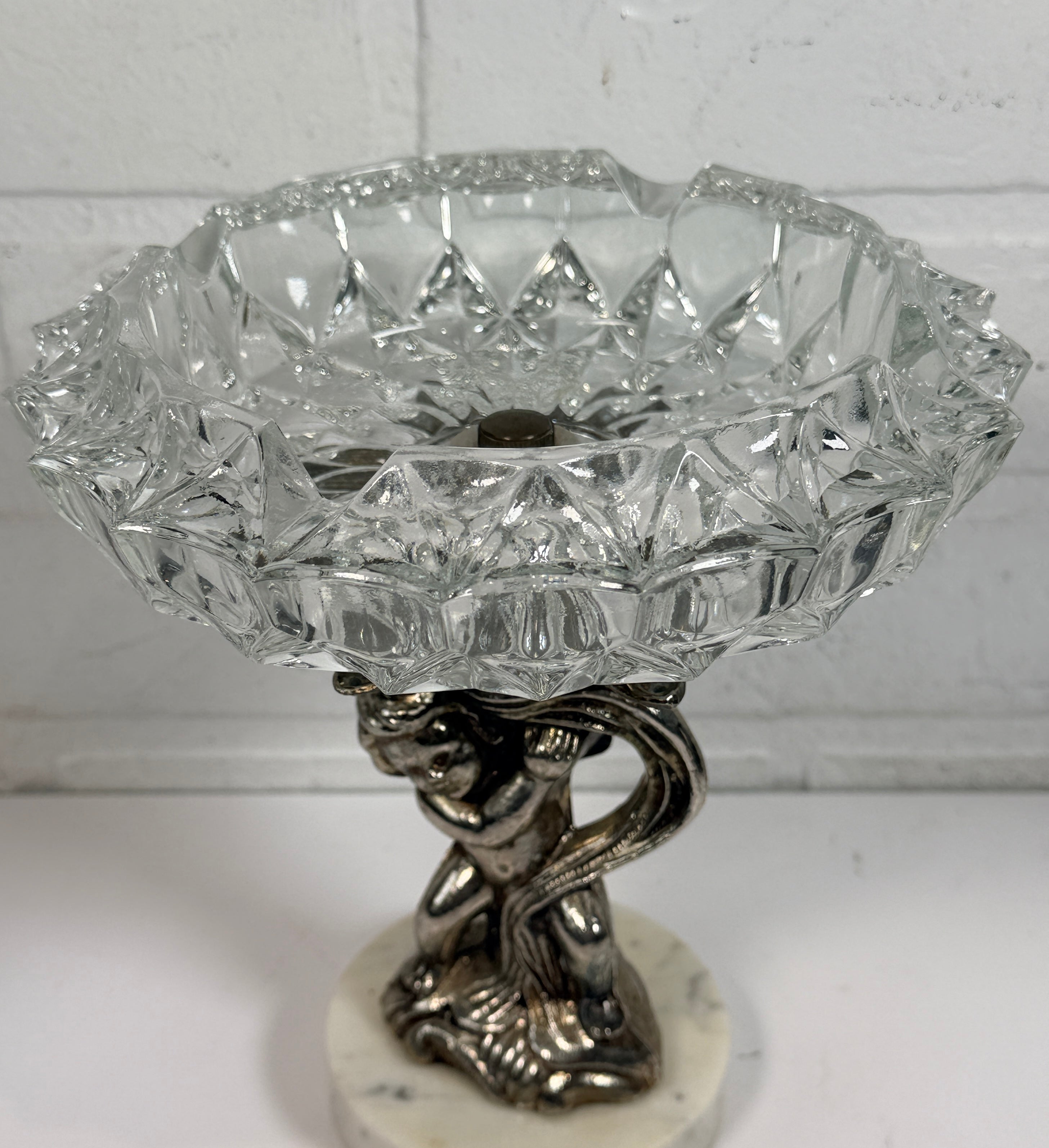 Vintage Hollywood Regency cherub pedestal dish with glass bowl and marble base. Elegant mid-century décor perfect for trinkets, candy, or display.