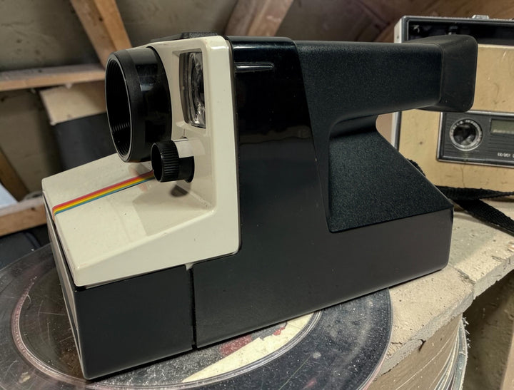 Vintage Polaroid OneStep SX-70 instant camera with rainbow stripe design. Untested and sold as-is. Great collectible retro display camera.