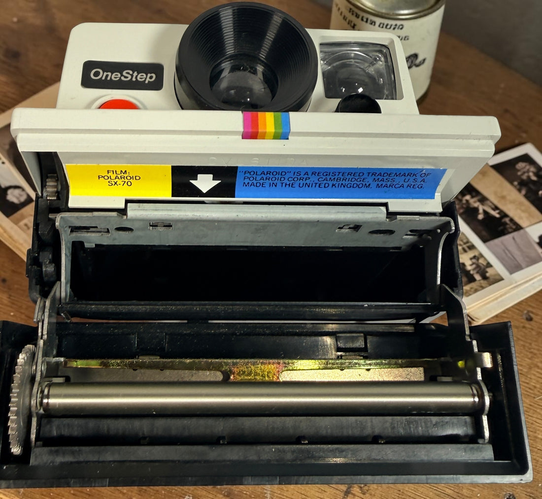 Vintage Polaroid OneStep SX-70 instant camera with rainbow stripe design. Untested and sold as-is. Great collectible retro display camera.