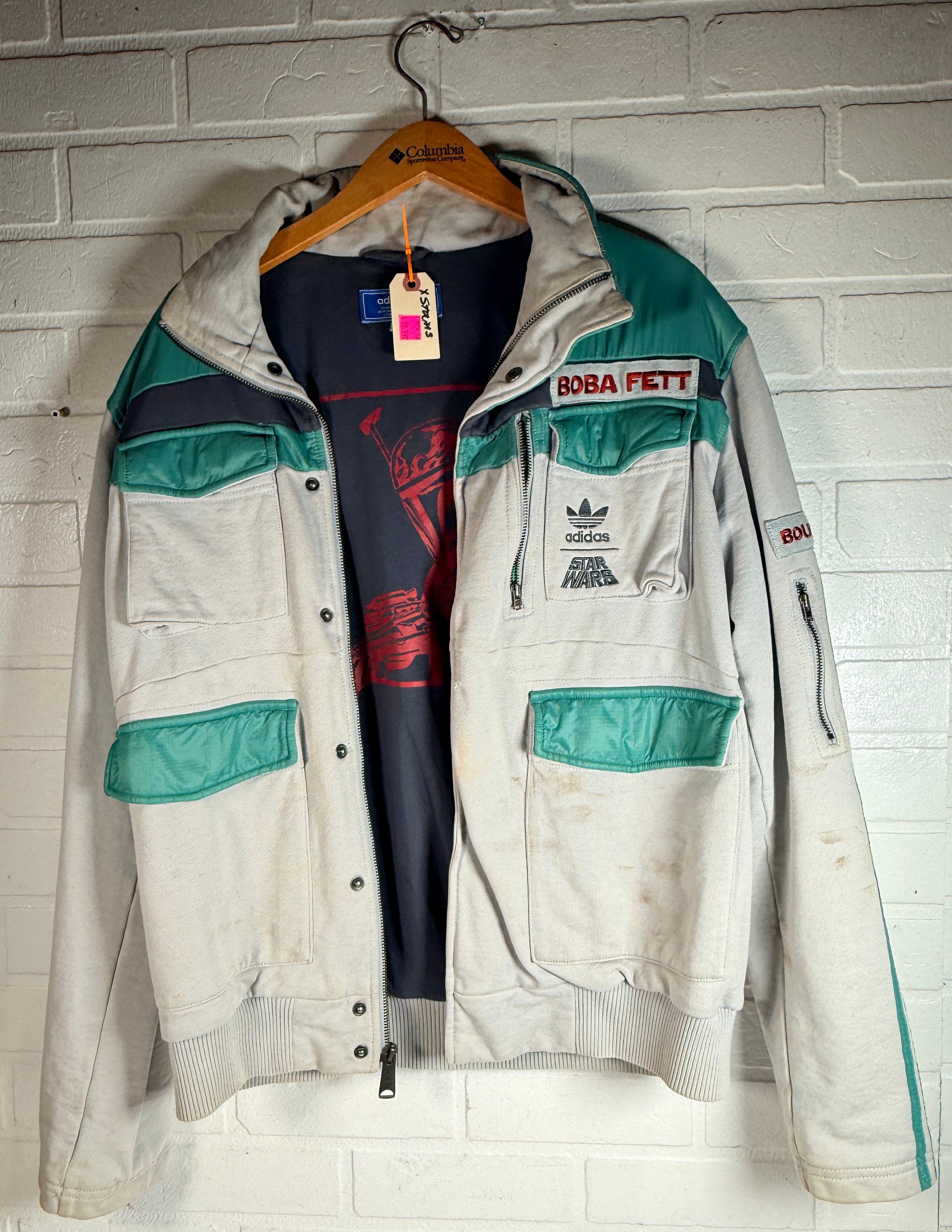 Adidas Star Wars Boba Fett jacket with tactical design and embroidered logos. Pre-owned with visible staining, priced for value and everyday wear appeal.