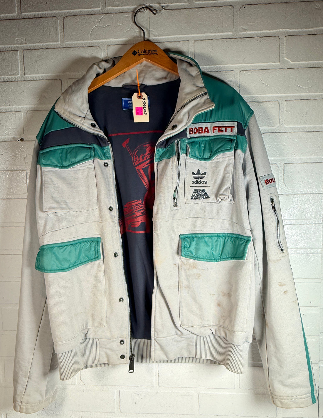 Adidas Star Wars Boba Fett jacket with tactical design and embroidered logos. Pre-owned with visible staining, priced for value and everyday wear appeal.