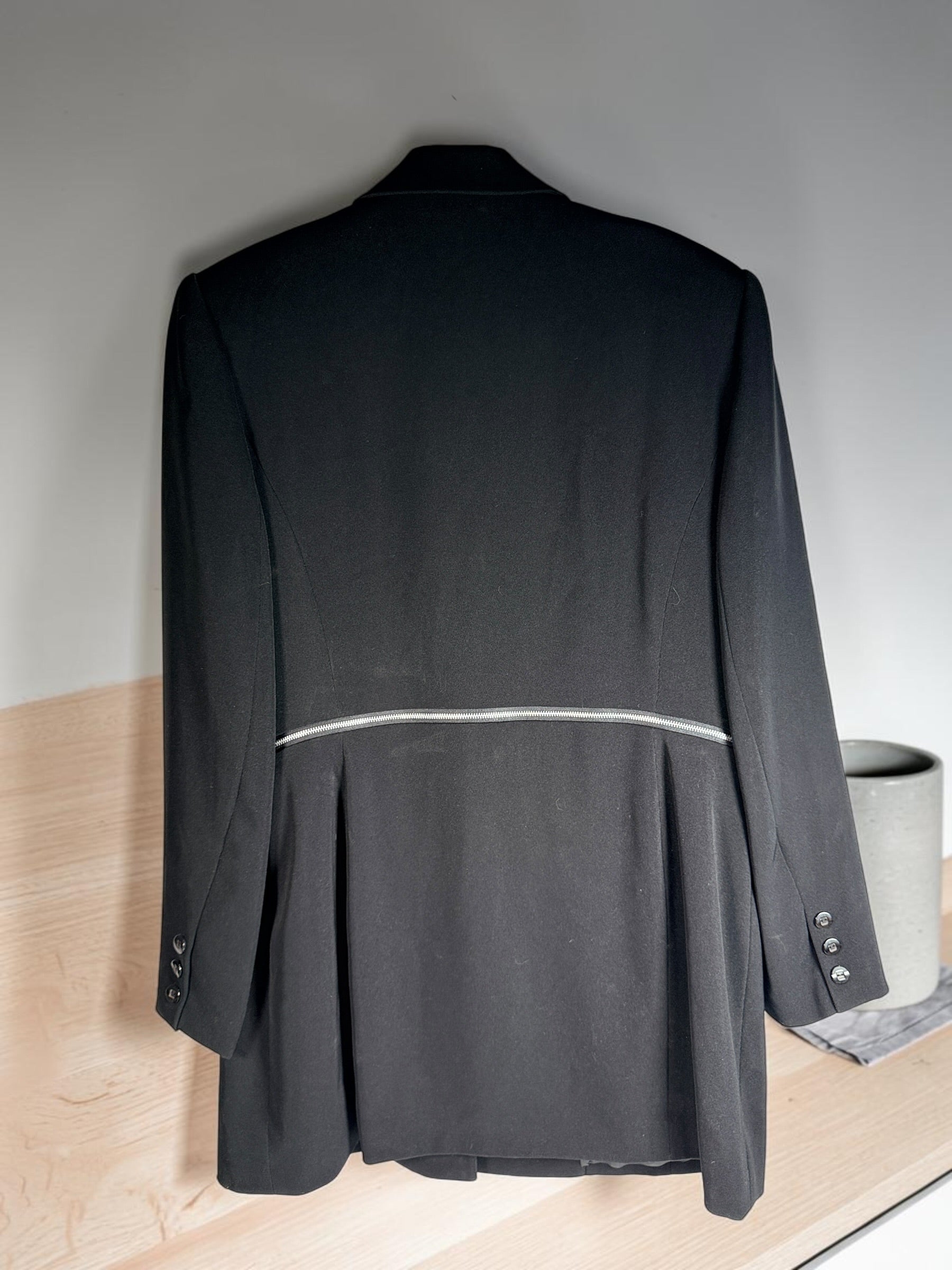 Vintage Simon Chang black blazer with zip waist detail, structured 90s silhouette, size 12. Classic tailored piece with unique design accent.