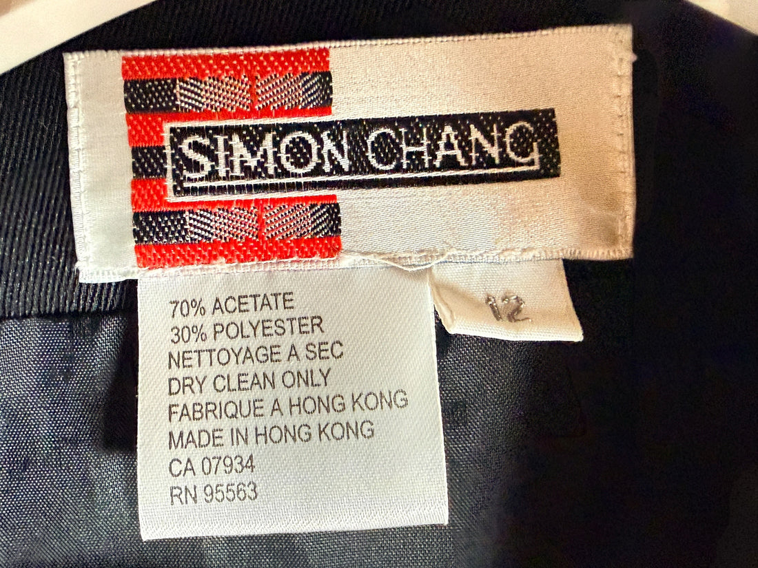 Vintage Simon Chang black blazer with zip waist detail, structured 90s silhouette, size 12. Classic tailored piece with unique design accent.