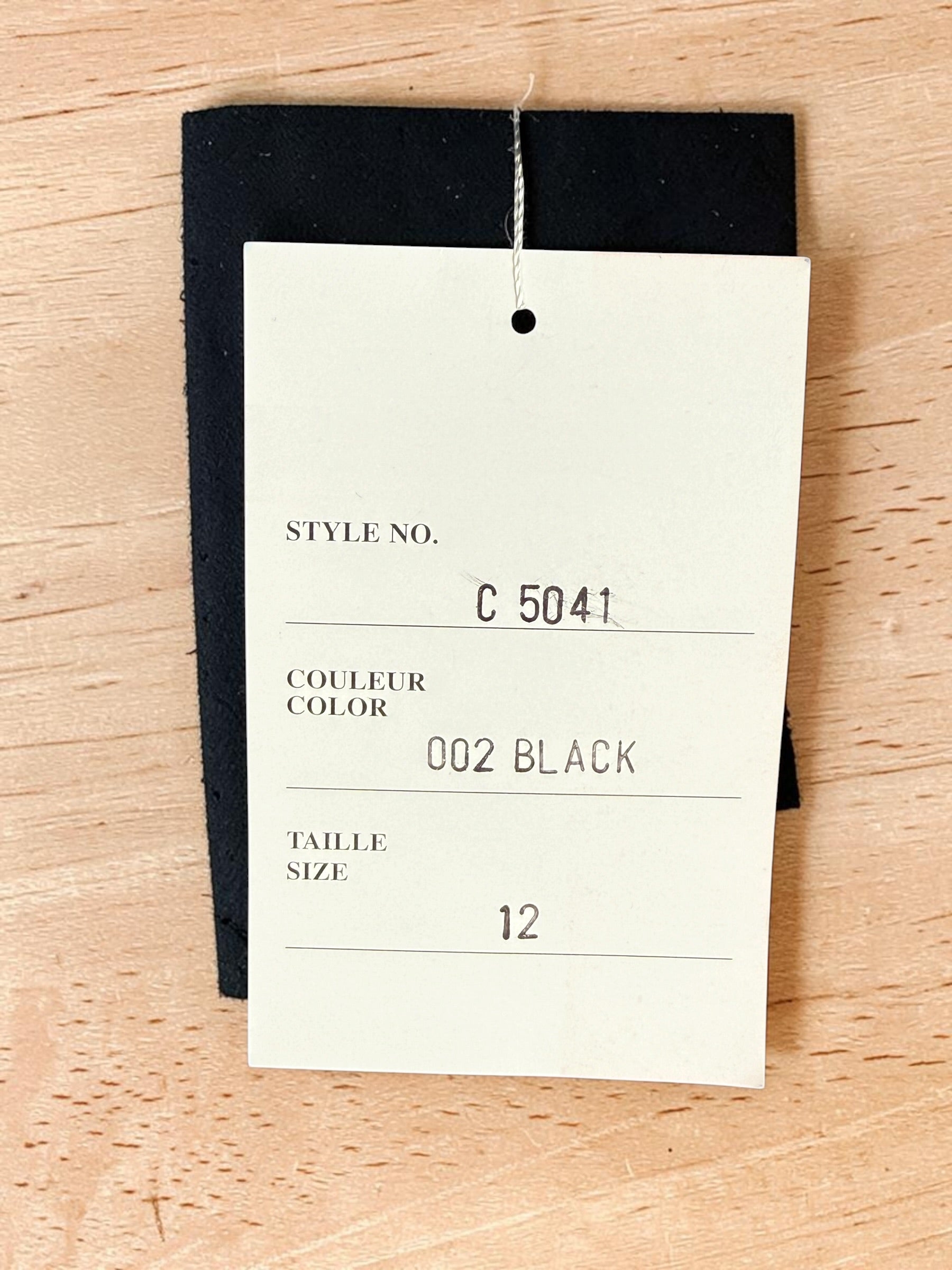 Vintage Simon Chang black blazer with zip waist detail, structured 90s silhouette, size 12. Classic tailored piece with unique design accent.