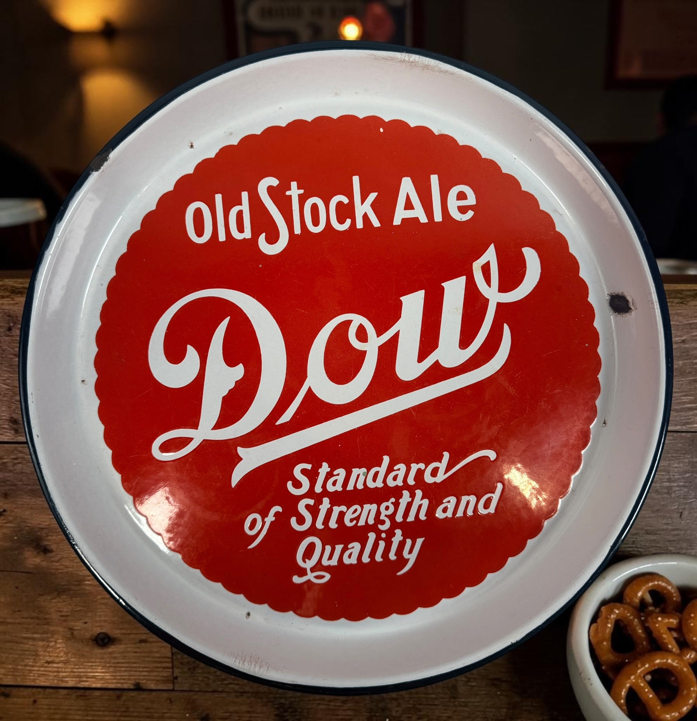 Vintage Dow Old Stock Ale beer advertising tray in enamel-coated metal. Classic Canadian brewery memorabilia with strong red graphics and tavern décor appeal.