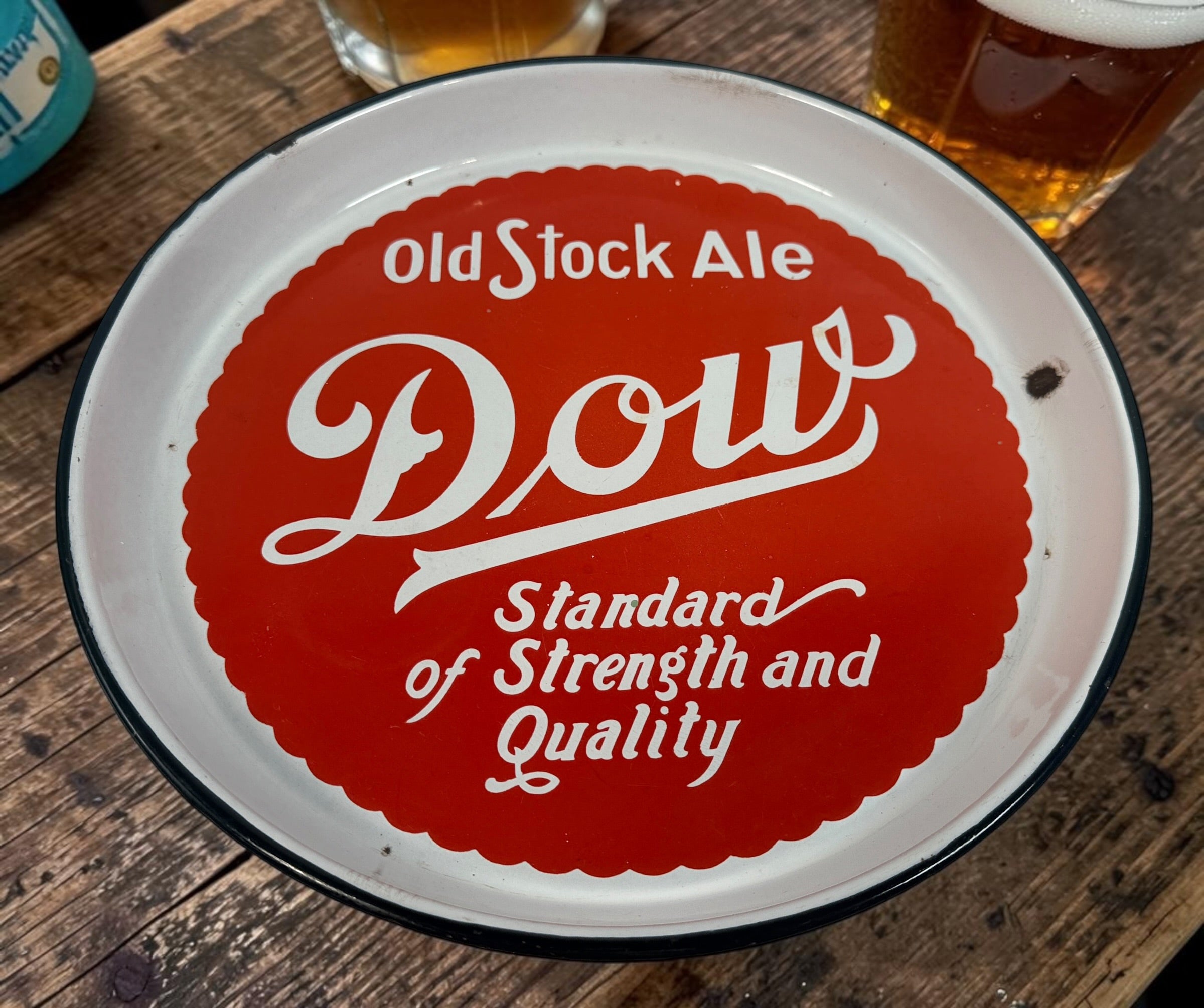 Vintage Dow Old Stock Ale beer advertising tray in enamel-coated metal. Classic Canadian brewery memorabilia with strong red graphics and tavern décor appeal.