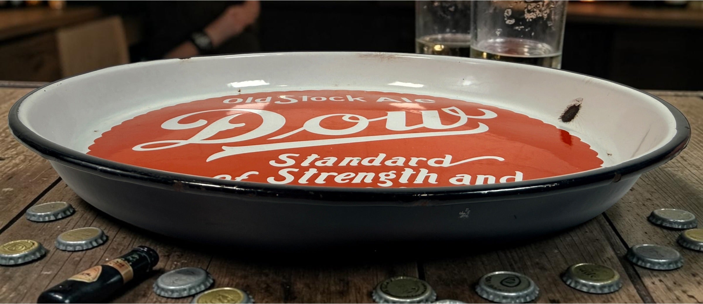 Vintage Dow Old Stock Ale beer advertising tray in enamel-coated metal. Classic Canadian brewery memorabilia with strong red graphics and tavern décor appeal.