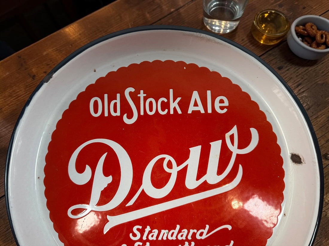 Vintage Dow Old Stock Ale beer advertising tray in enamel-coated metal. Classic Canadian brewery memorabilia with strong red graphics and tavern décor appeal.