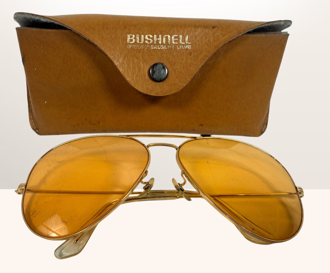 Vintage Bushnell B&amp;L aviator sunglasses with amber lenses and original case, made in USA retro shooting and driving glasses from the 1970s era.