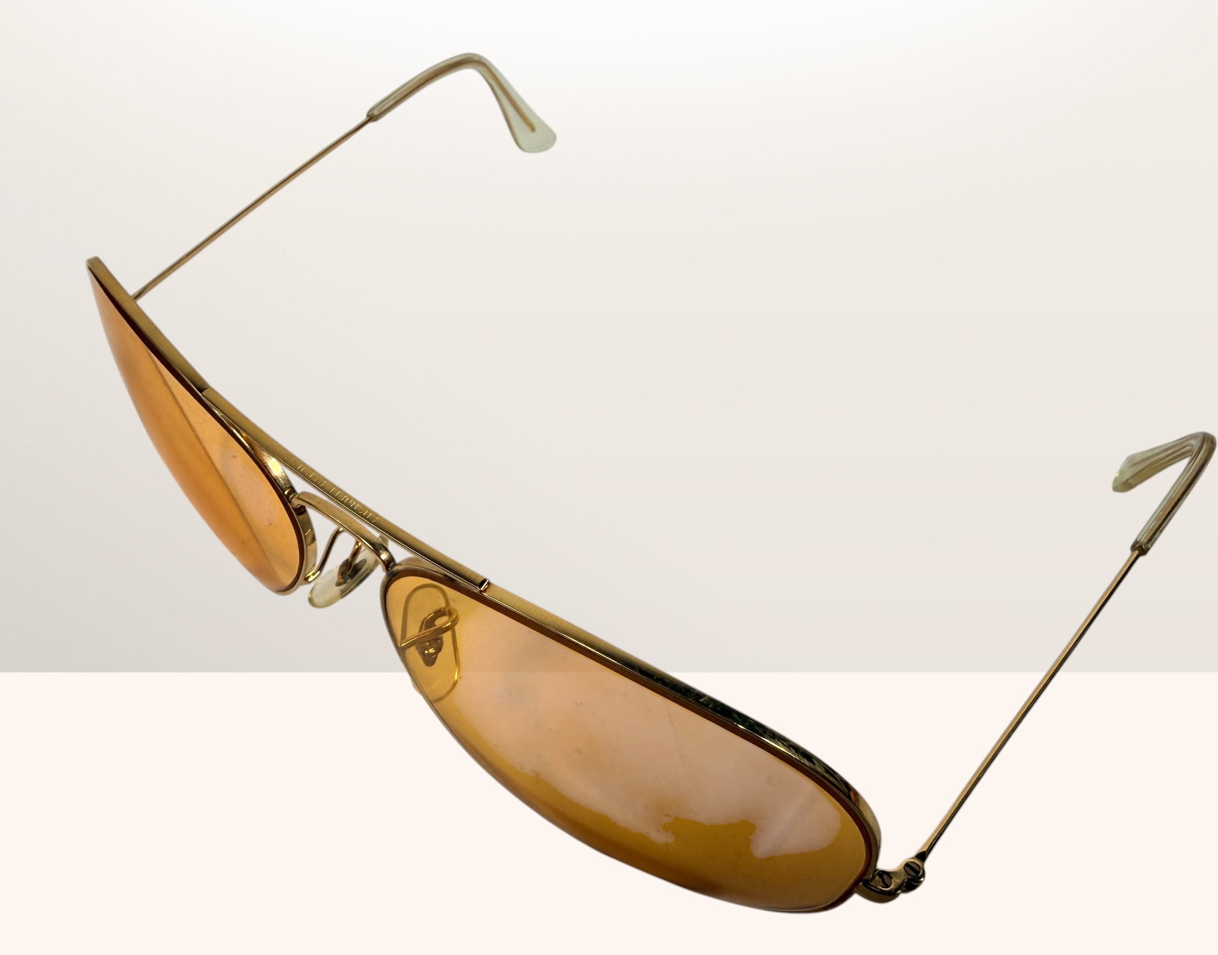 Vintage Bushnell B&amp;L aviator sunglasses with amber lenses and original case, made in USA retro shooting and driving glasses from the 1970s era.