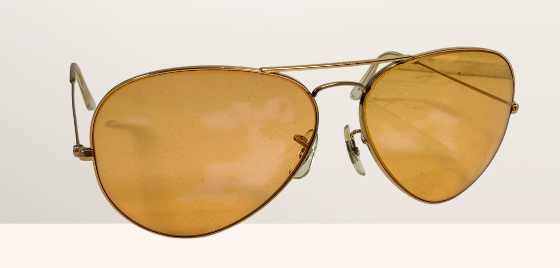 Vintage Bushnell B&amp;L aviator sunglasses with amber lenses and original case, made in USA retro shooting and driving glasses from the 1970s era.