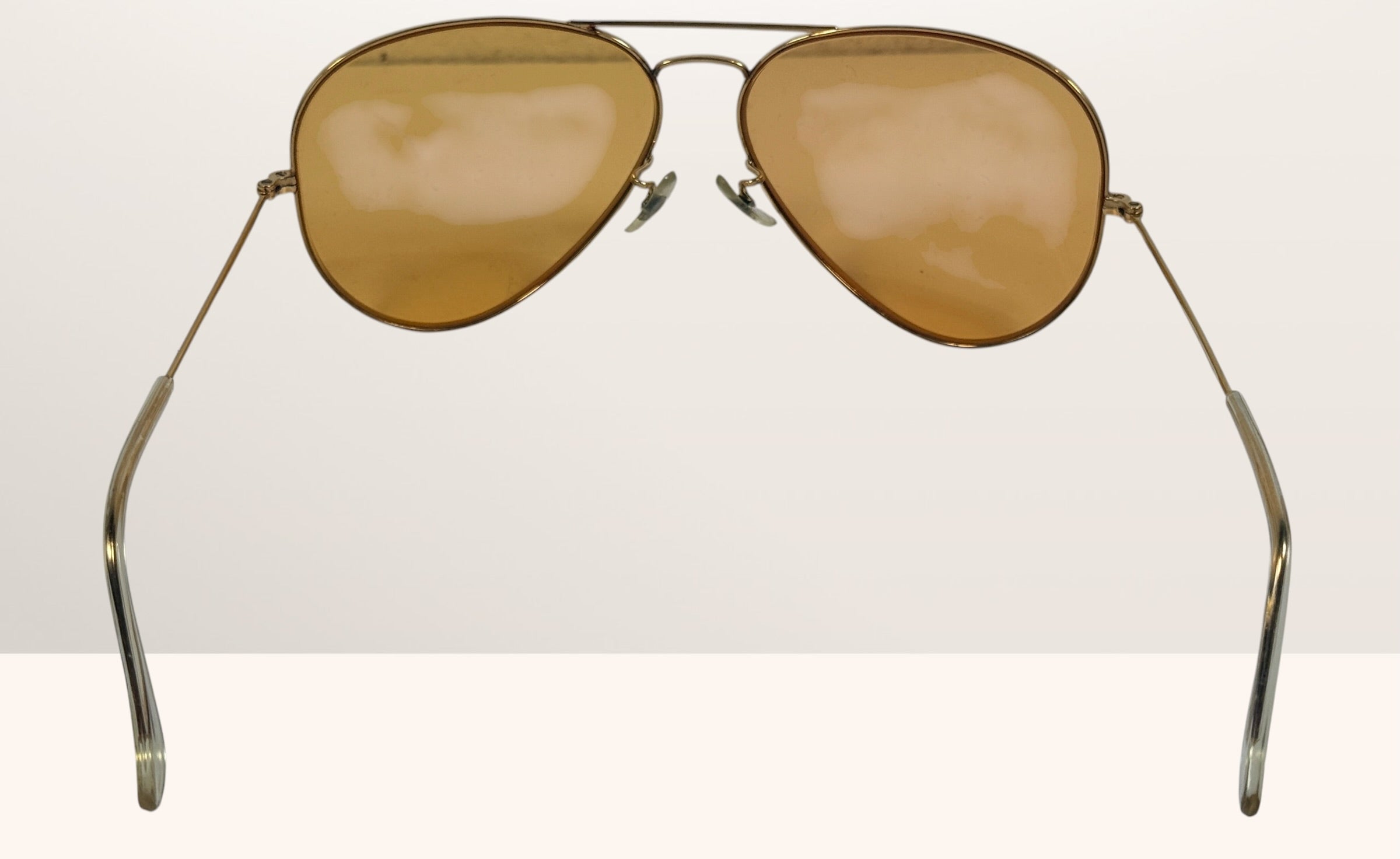 Vintage Bushnell B&amp;L aviator sunglasses with amber lenses and original case, made in USA retro shooting and driving glasses from the 1970s era.