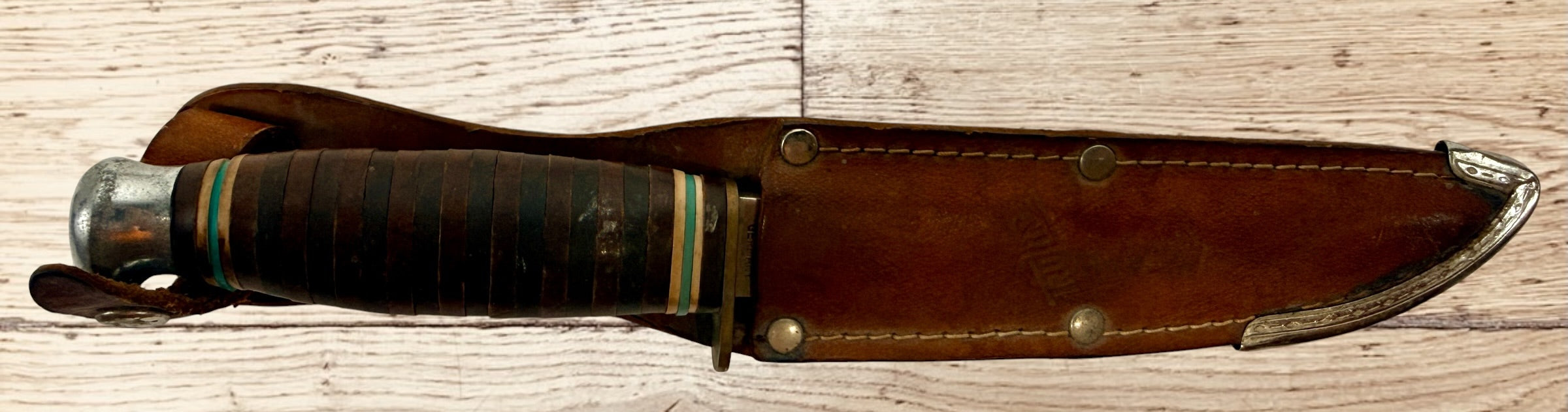 Vintage TRULINE Solingen Germany hunting knife with original leather sheath. Classic stacked leather fixed blade collectible from the mid-century era.