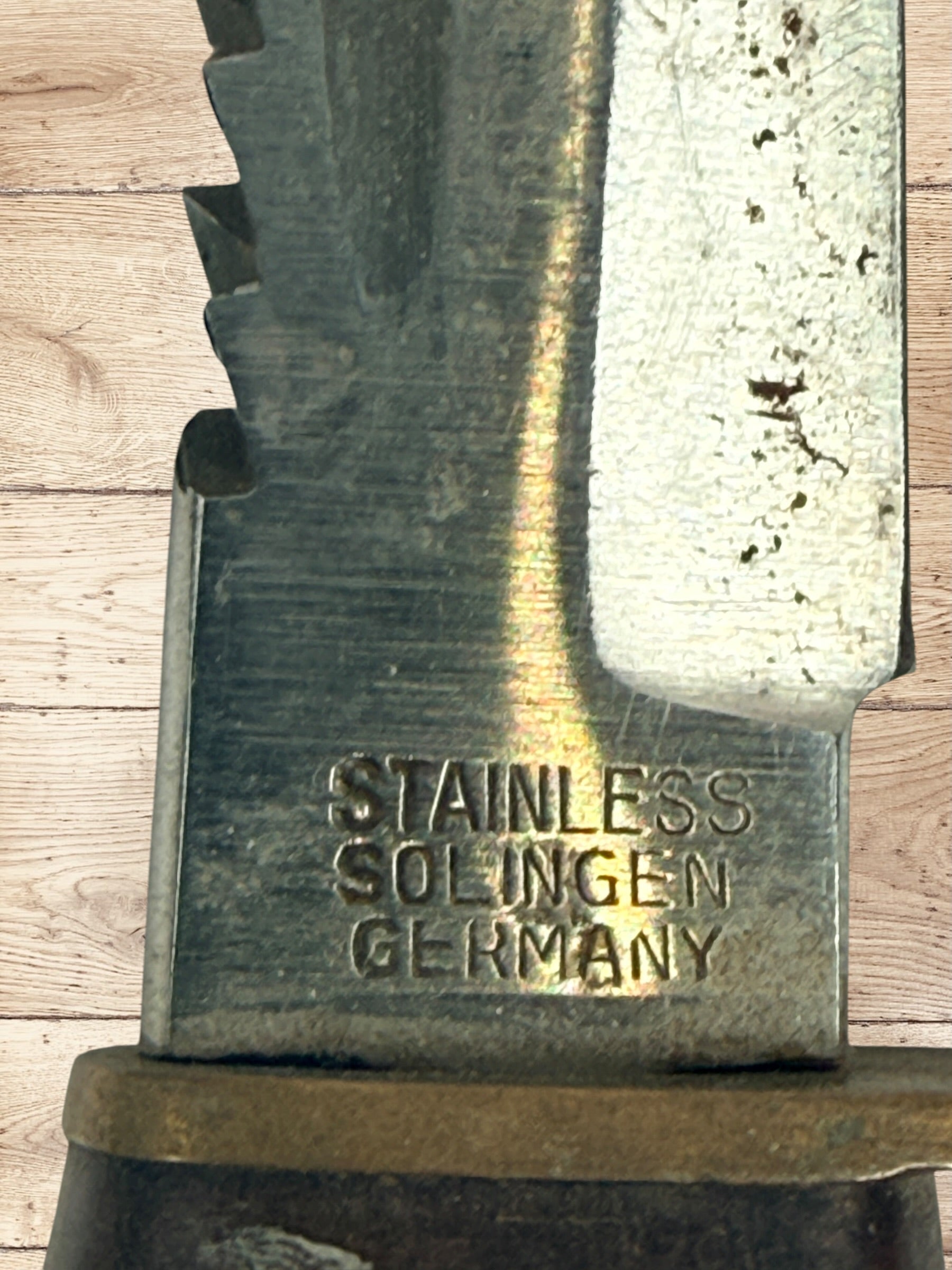 Vintage TRULINE Solingen Germany hunting knife with original leather sheath. Classic stacked leather fixed blade collectible from the mid-century era.