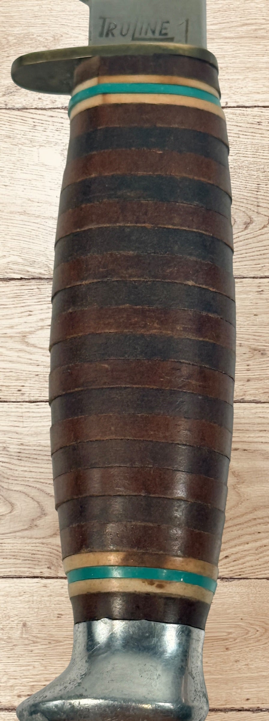 Vintage TRULINE Solingen Germany hunting knife with original leather sheath. Classic stacked leather fixed blade collectible from the mid-century era.