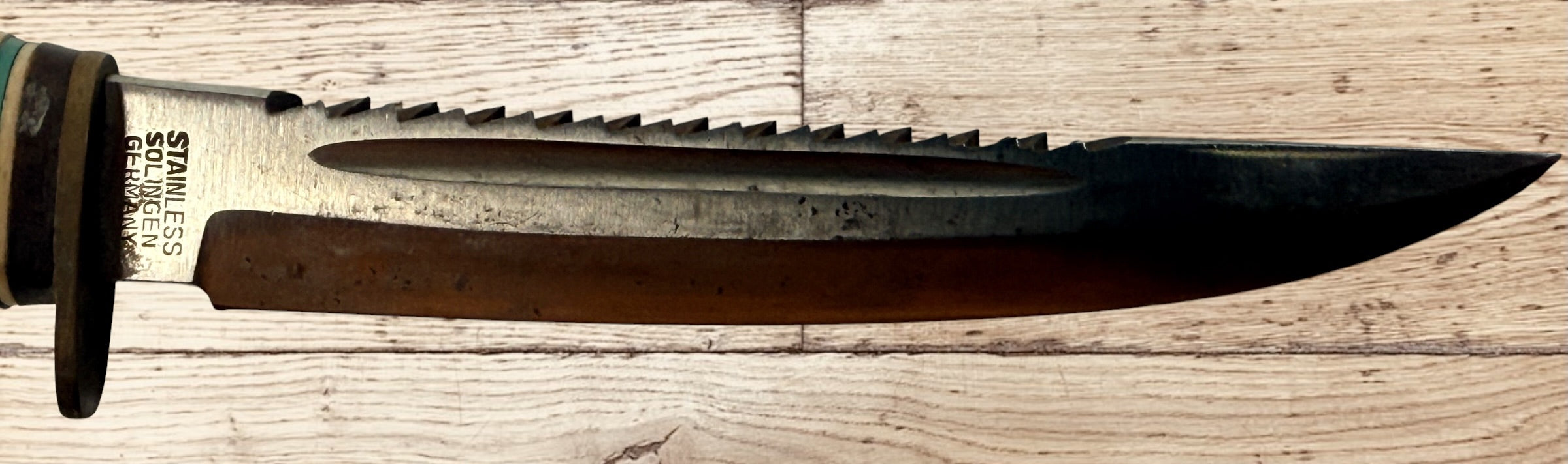 Vintage TRULINE Solingen Germany hunting knife with original leather sheath. Classic stacked leather fixed blade collectible from the mid-century era.