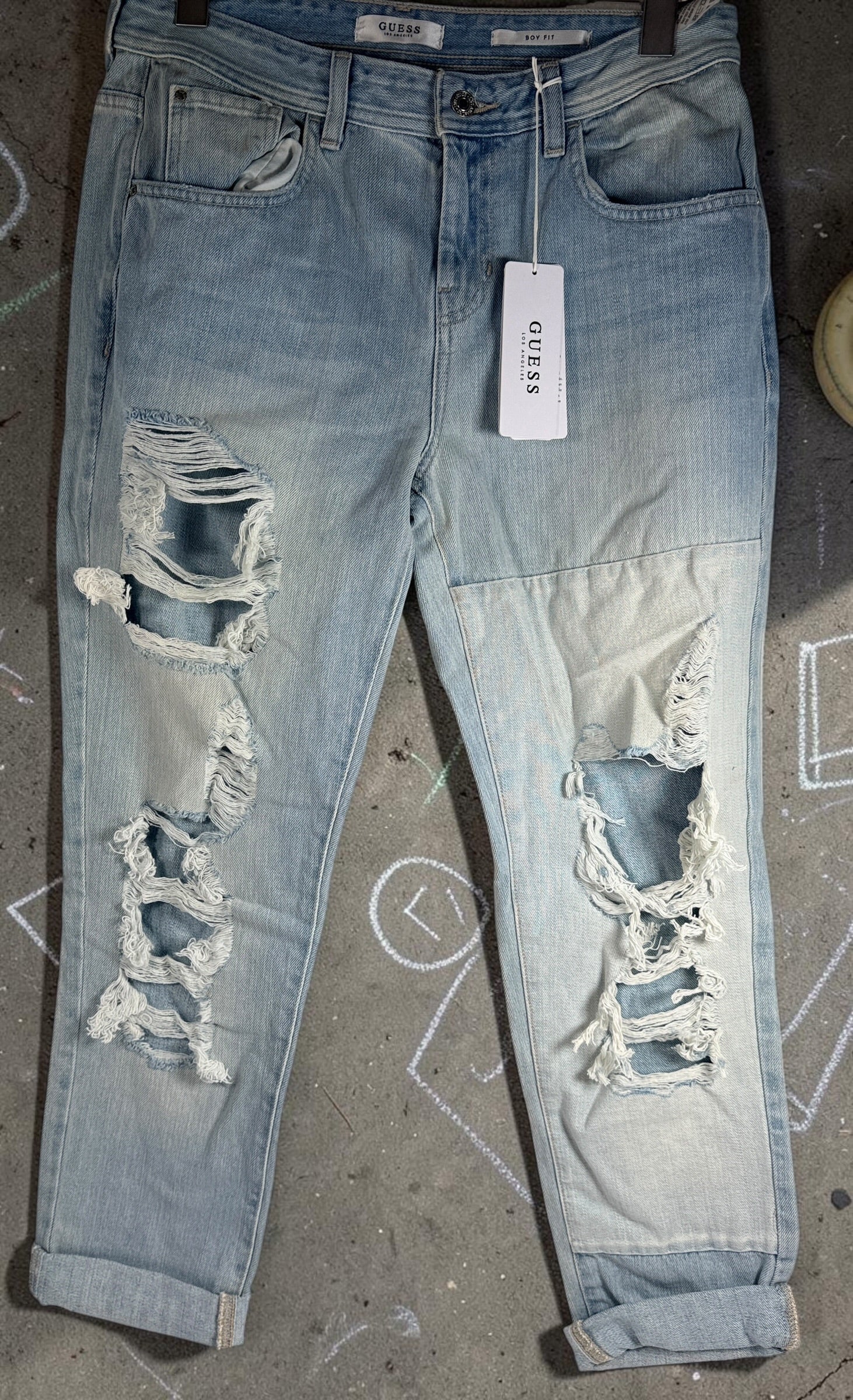 GUESS Boy Fit distressed jeans in light wash denim, size 29, new with tags. Trendy ripped boyfriend-fit jeans with modern Y2K streetwear style.