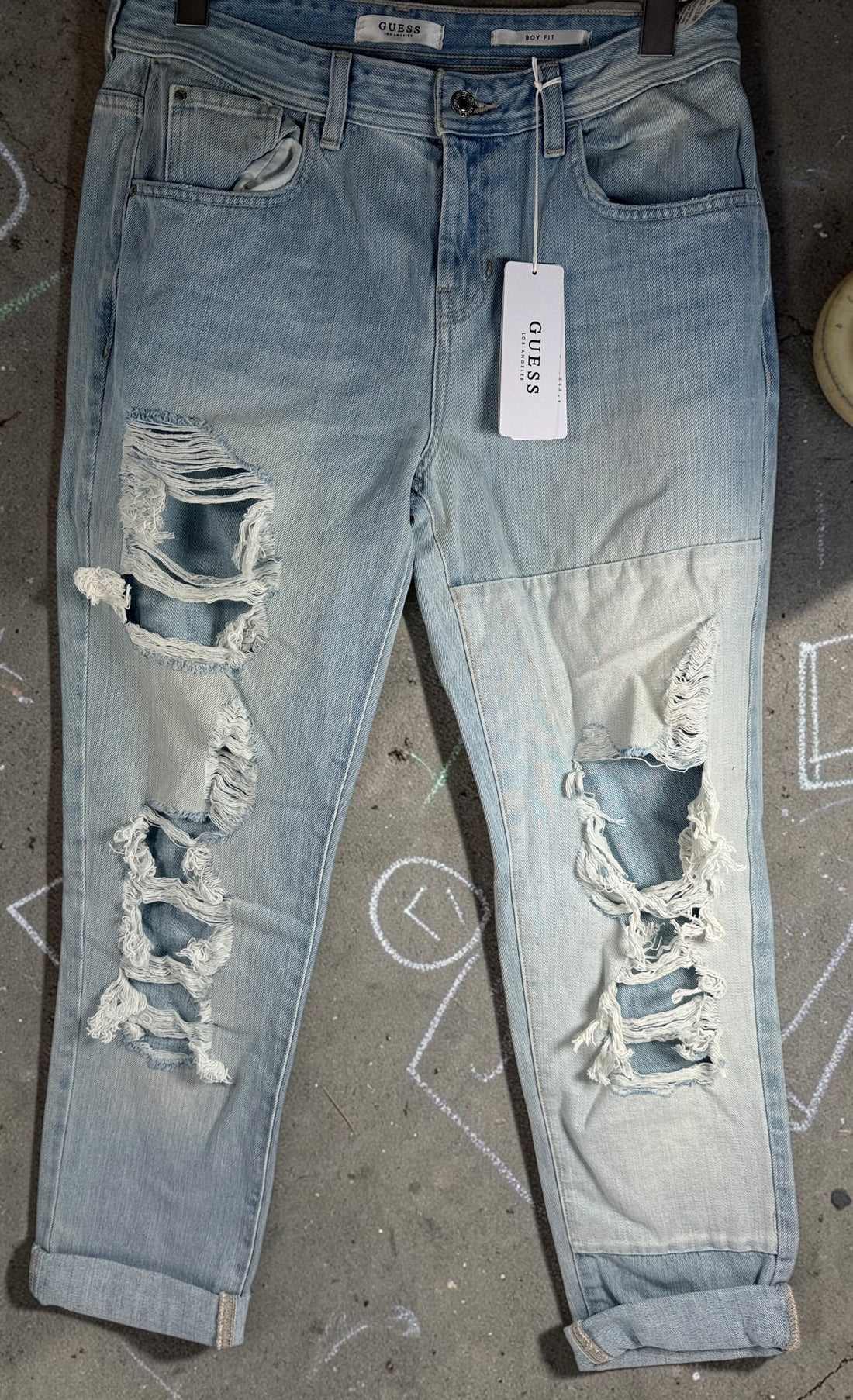 GUESS Boy Fit distressed jeans in light wash denim, size 29, new with tags. Trendy ripped boyfriend-fit jeans with modern Y2K streetwear style.
