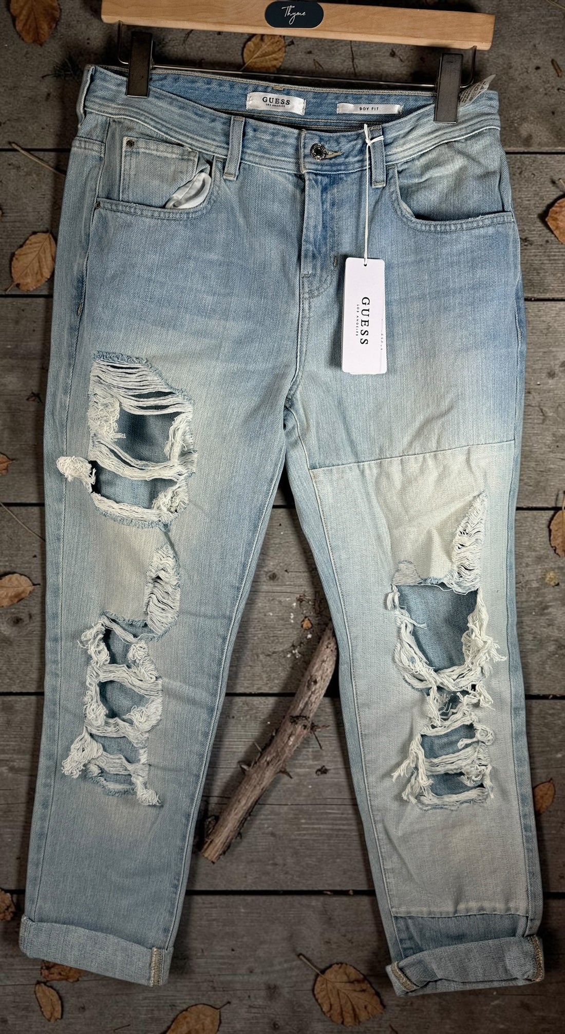 GUESS Boy Fit distressed jeans in light wash denim, size 29, new with tags. Trendy ripped boyfriend-fit jeans with modern Y2K streetwear style.
