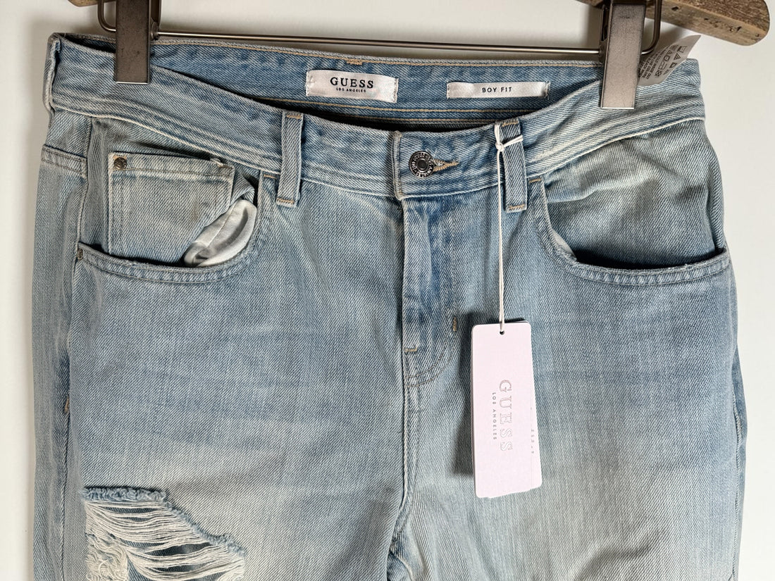 GUESS Boy Fit distressed jeans in light wash denim, size 29, new with tags. Trendy ripped boyfriend-fit jeans with modern Y2K streetwear style.