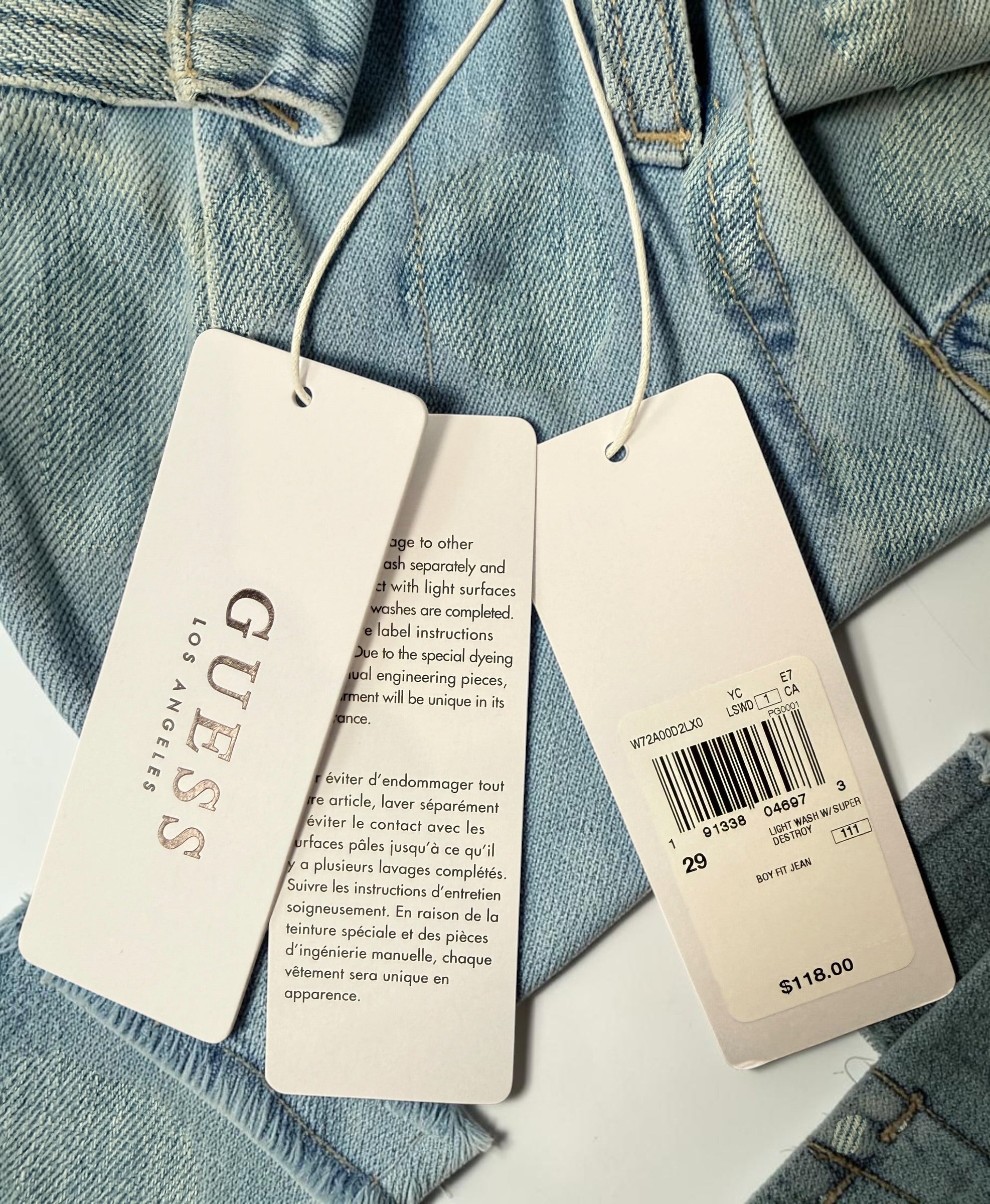 GUESS Boy Fit distressed jeans in light wash denim, size 29, new with tags. Trendy ripped boyfriend-fit jeans with modern Y2K streetwear style.