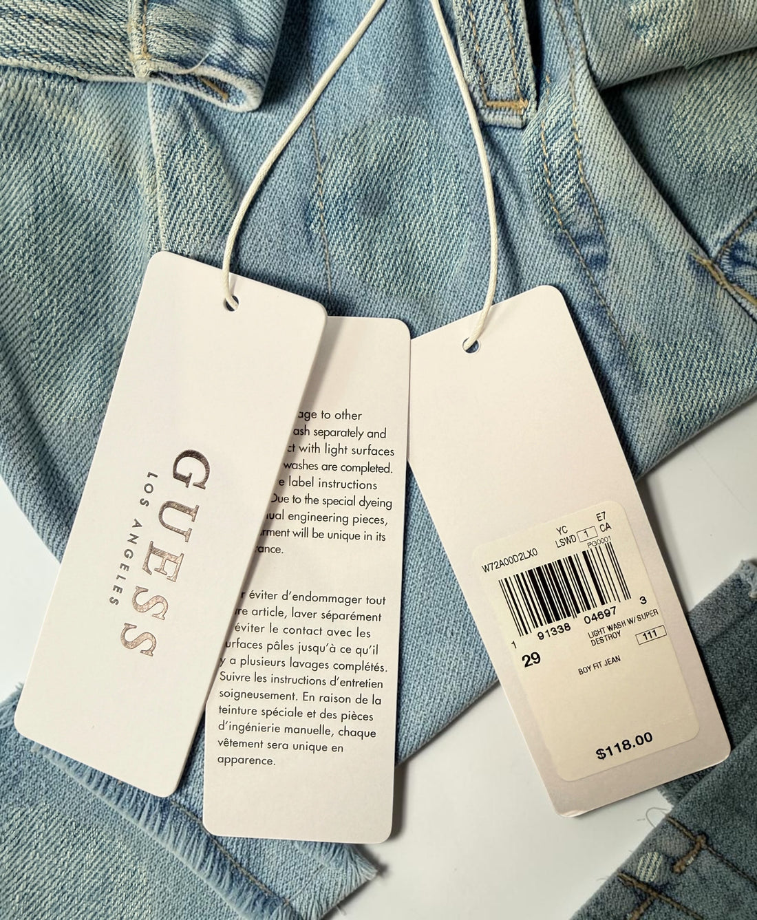 GUESS Boy Fit distressed jeans in light wash denim, size 29, new with tags. Trendy ripped boyfriend-fit jeans with modern Y2K streetwear style.