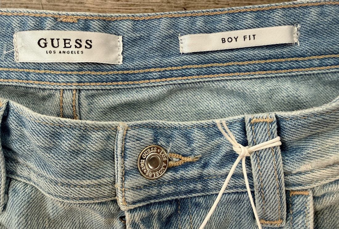 GUESS Boy Fit distressed jeans in light wash denim, size 29, new with tags. Trendy ripped boyfriend-fit jeans with modern Y2K streetwear style.