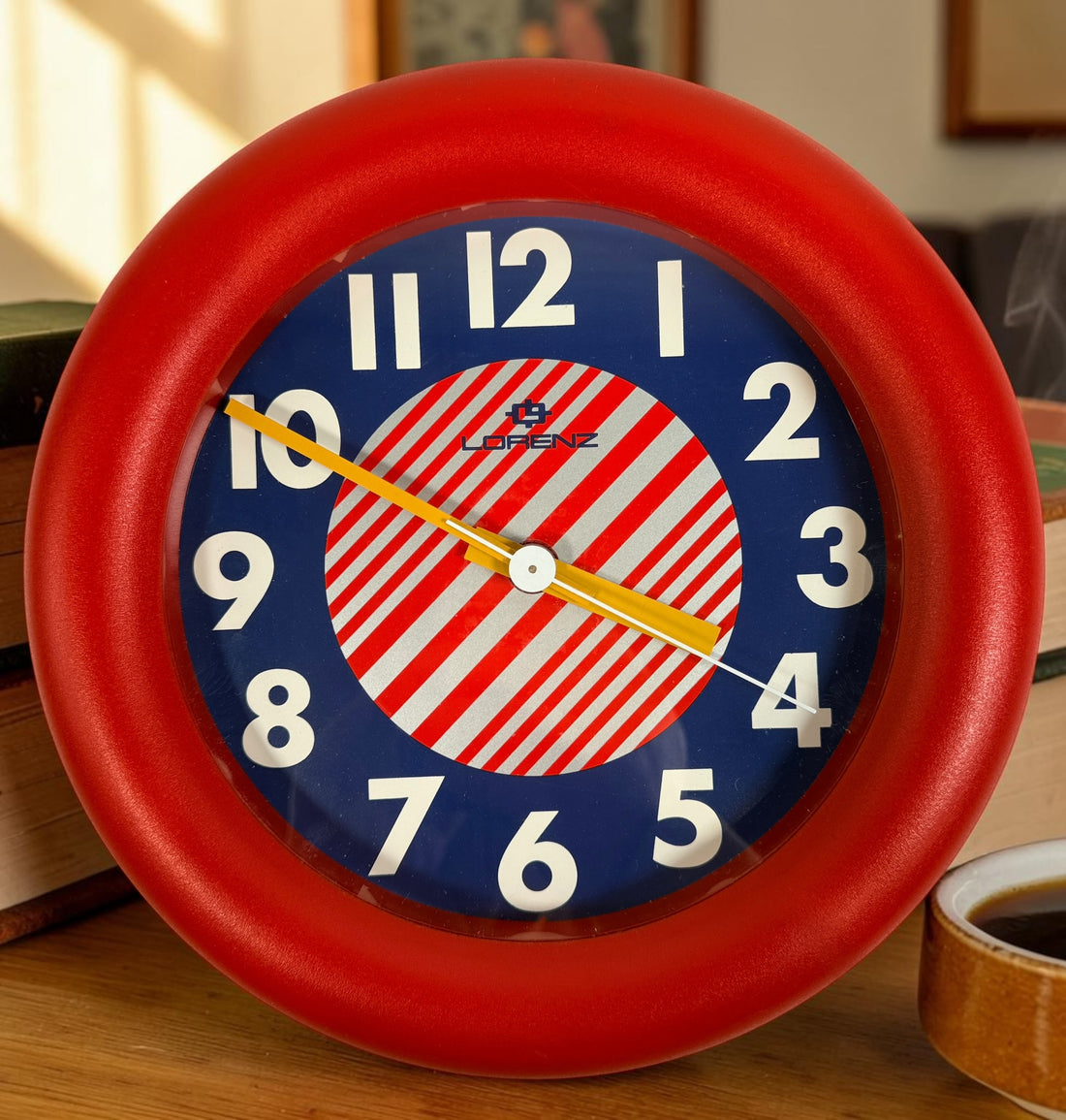 Vintage Italian Lorenz Design postmodern wall clock in bold red Memphis style with geometric dial and 1980s space-age aesthetic.