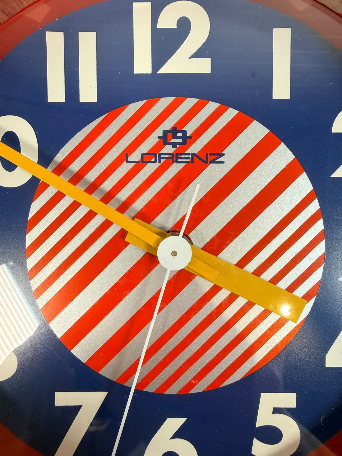 Vintage Italian Lorenz Design postmodern wall clock in bold red Memphis style with geometric dial and 1980s space-age aesthetic.