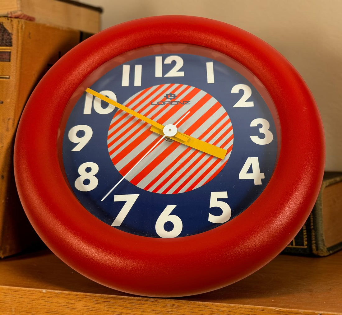 Vintage Italian Lorenz Design postmodern wall clock in bold red Memphis style with geometric dial and 1980s space-age aesthetic.