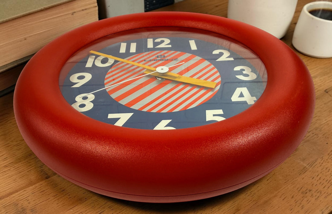 Vintage Italian Lorenz Design postmodern wall clock in bold red Memphis style with geometric dial and 1980s space-age aesthetic.