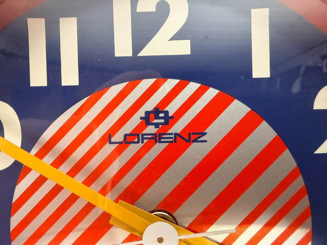 Vintage Italian Lorenz Design postmodern wall clock in bold red Memphis style with geometric dial and 1980s space-age aesthetic.