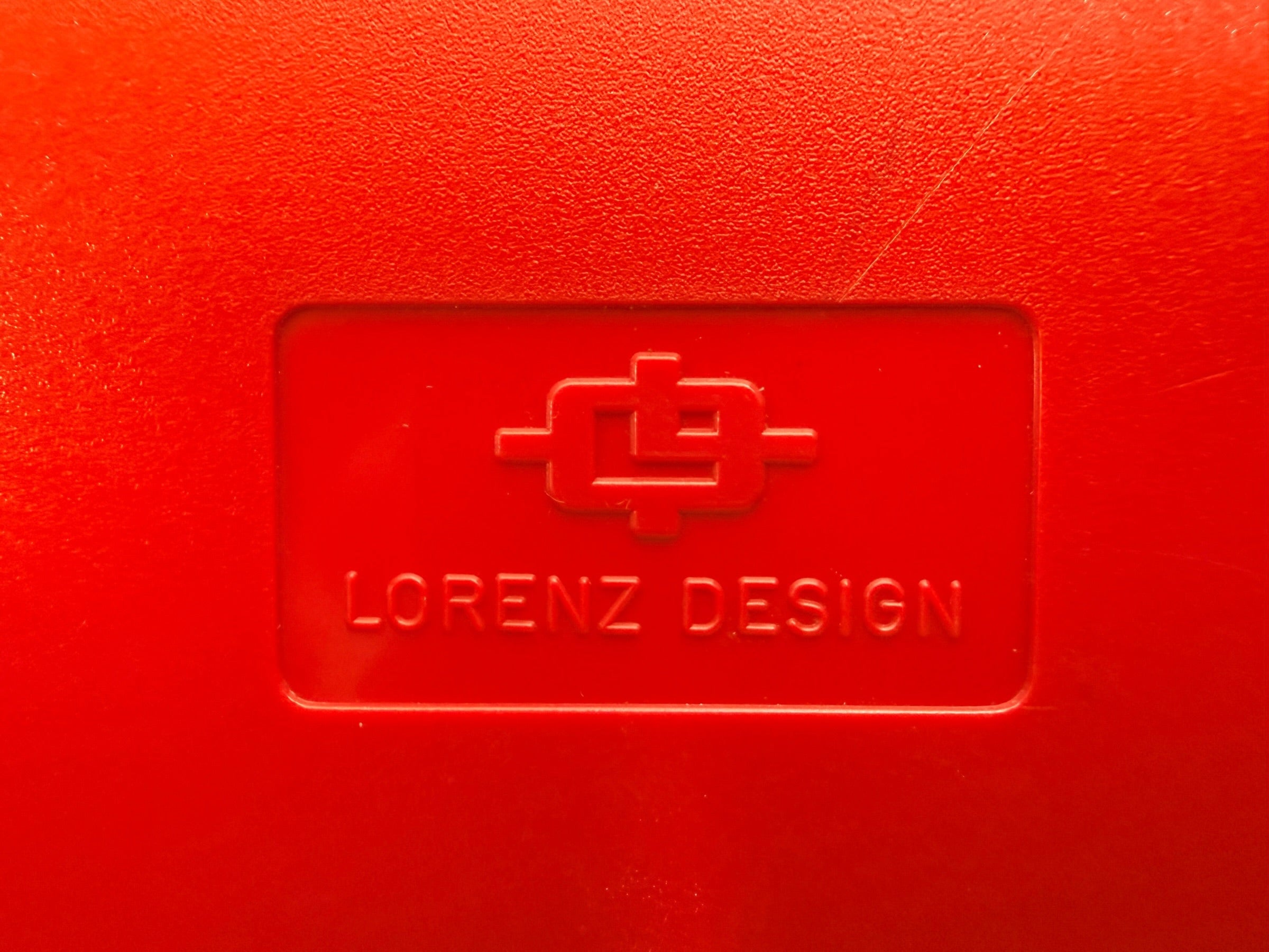 Vintage Italian Lorenz Design postmodern wall clock in bold red Memphis style with geometric dial and 1980s space-age aesthetic.