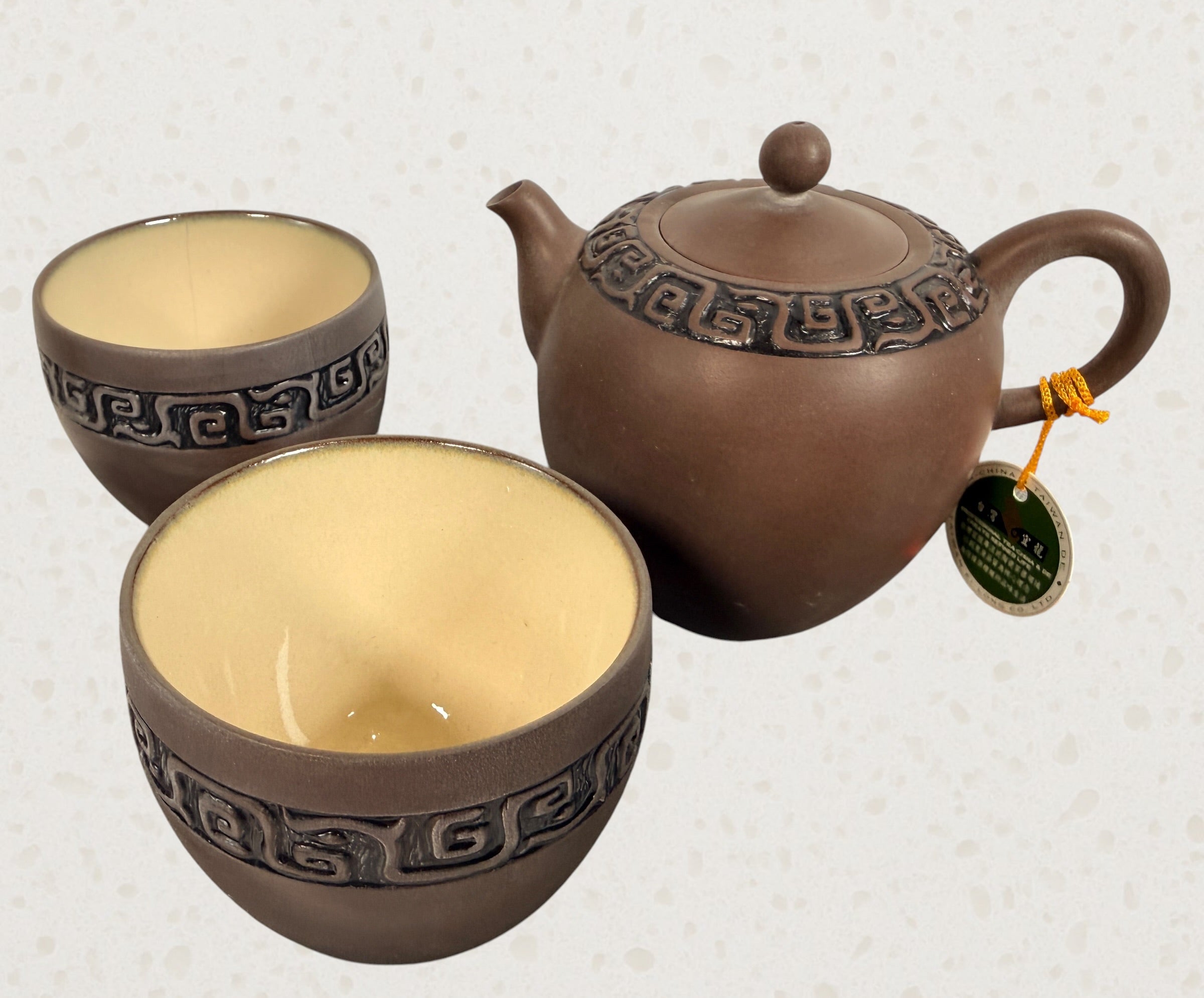 Modern Taiwanese clay tea set with teapot and two cups in original satin-lined gift box featuring Yixing-inspired styling and geometric carved detailing.