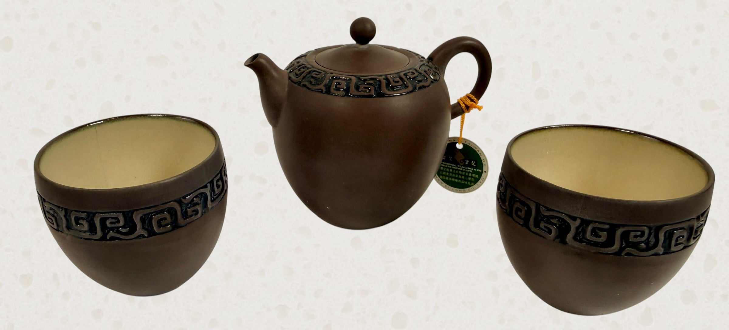 Modern Taiwanese clay tea set with teapot and two cups in original satin-lined gift box featuring Yixing-inspired styling and geometric carved detailing.
