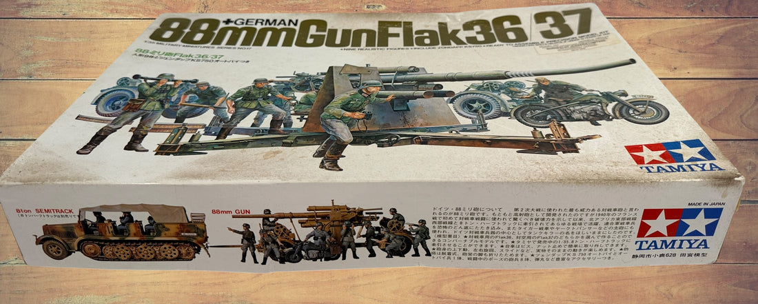 Vintage Tamiya 1/35 German 88mm Flak 36/37 model kit made in Japan. Rare early military miniature series with original box and unbuilt parts.