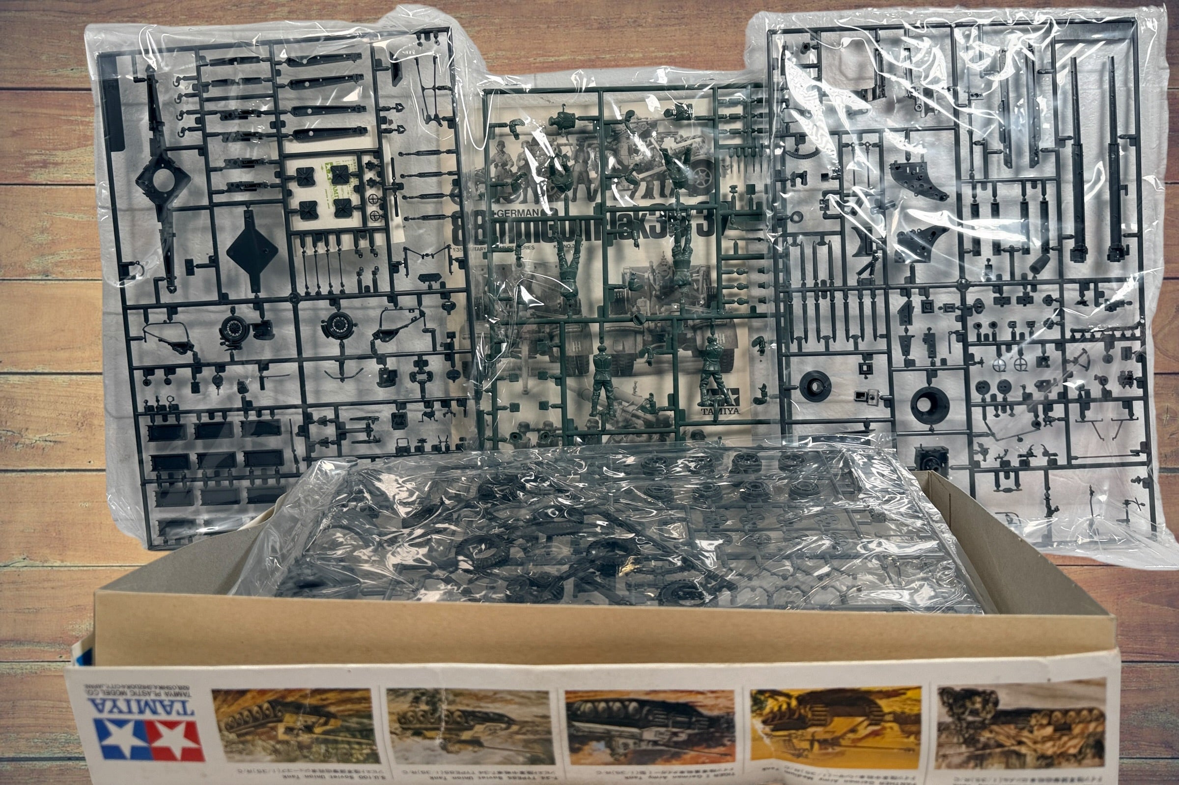 Vintage Tamiya 1/35 German 88mm Flak 36/37 model kit made in Japan. Rare early military miniature series with original box and unbuilt parts.