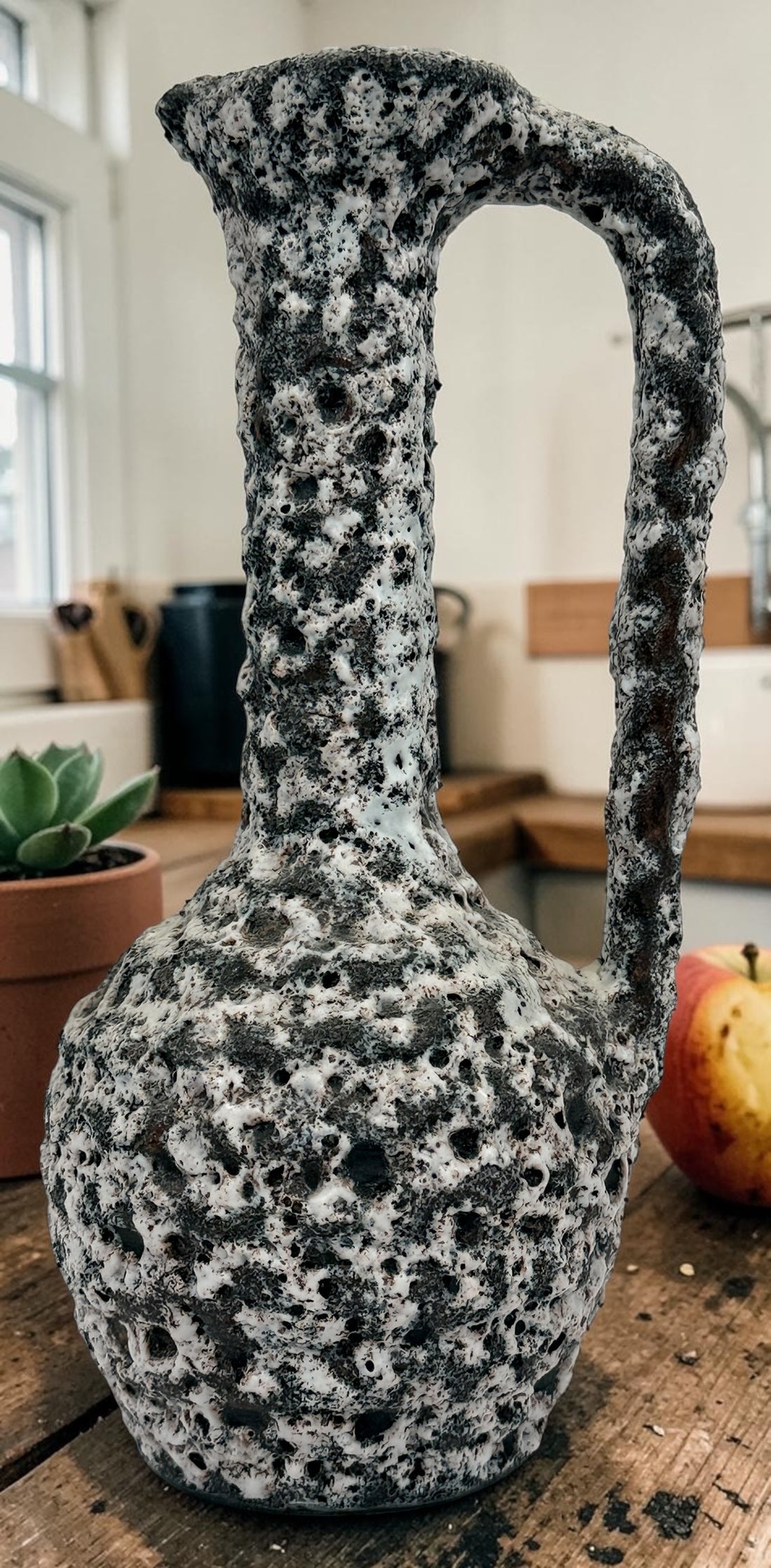 Vintage French brutalist lava glaze vase by Puy Mary featuring volcanic black and white texture and sculptural 1970s ceramic design.