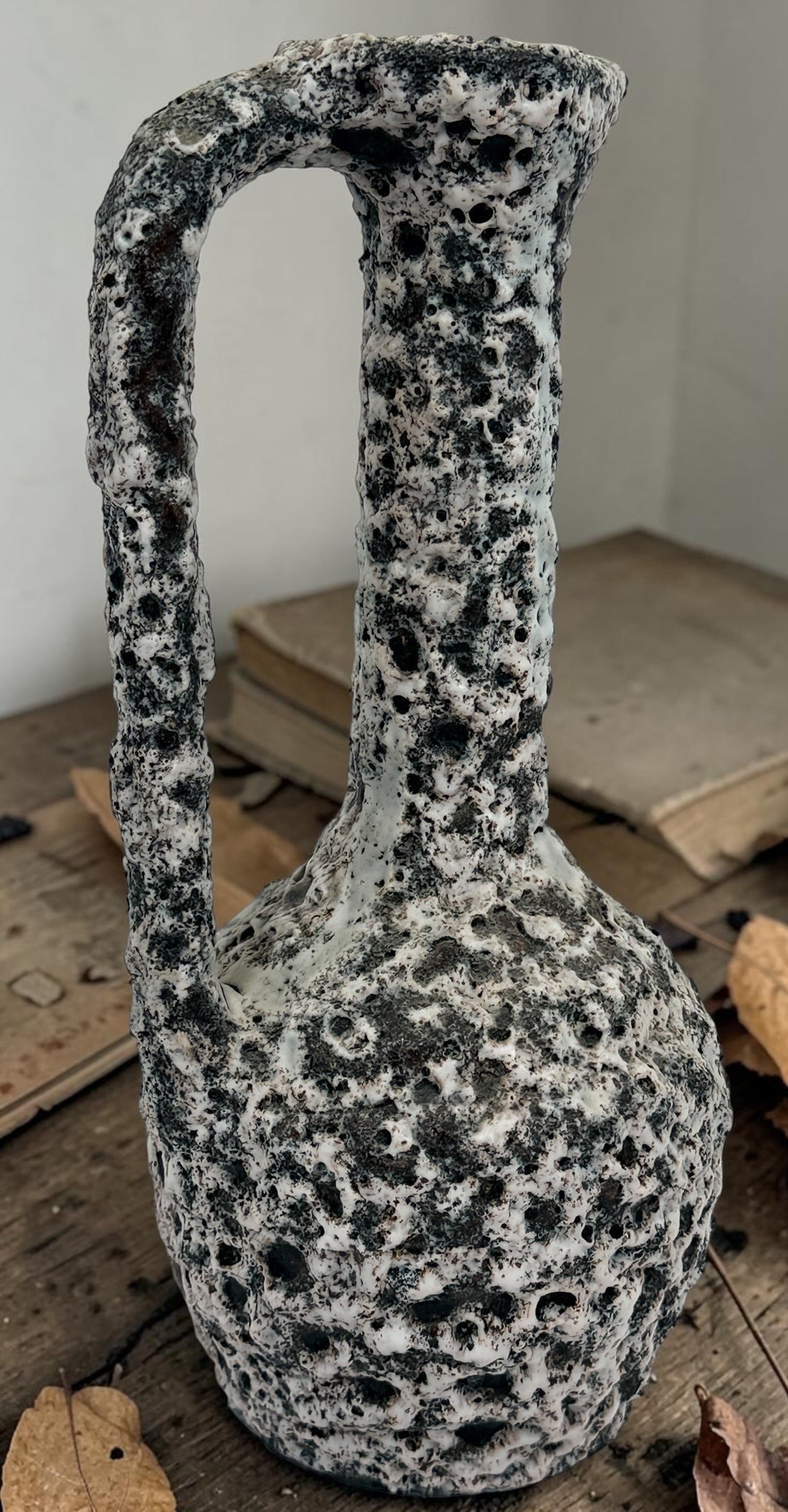 Vintage French brutalist lava glaze vase by Puy Mary featuring volcanic black and white texture and sculptural 1970s ceramic design.