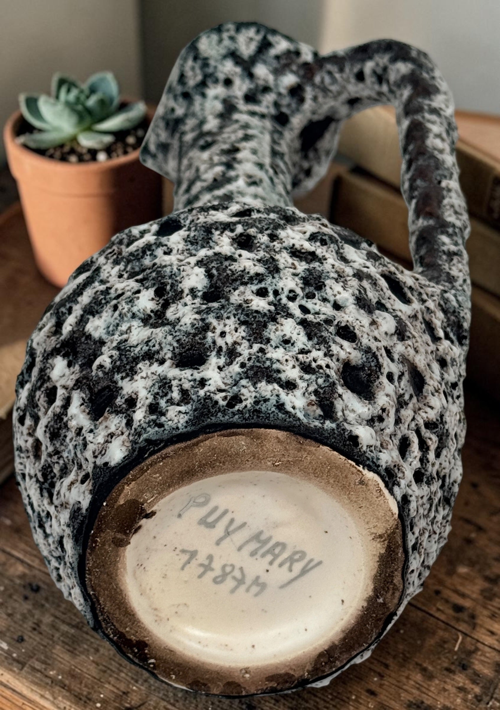 Vintage French brutalist lava glaze vase by Puy Mary featuring volcanic black and white texture and sculptural 1970s ceramic design.