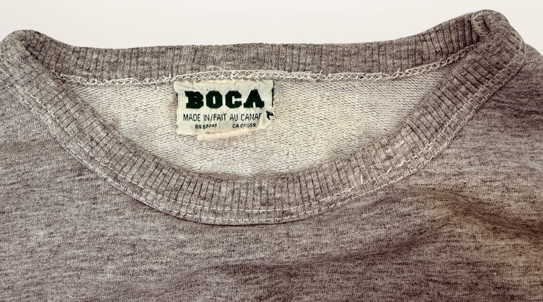 Vintage BOCA Canadian-made crewneck sweatshirt in grey with varsity logo styling and relaxed 90s athletic wear fit.