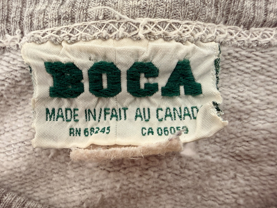 Vintage BOCA Canadian-made crewneck sweatshirt in grey with varsity logo styling and relaxed 90s athletic wear fit.