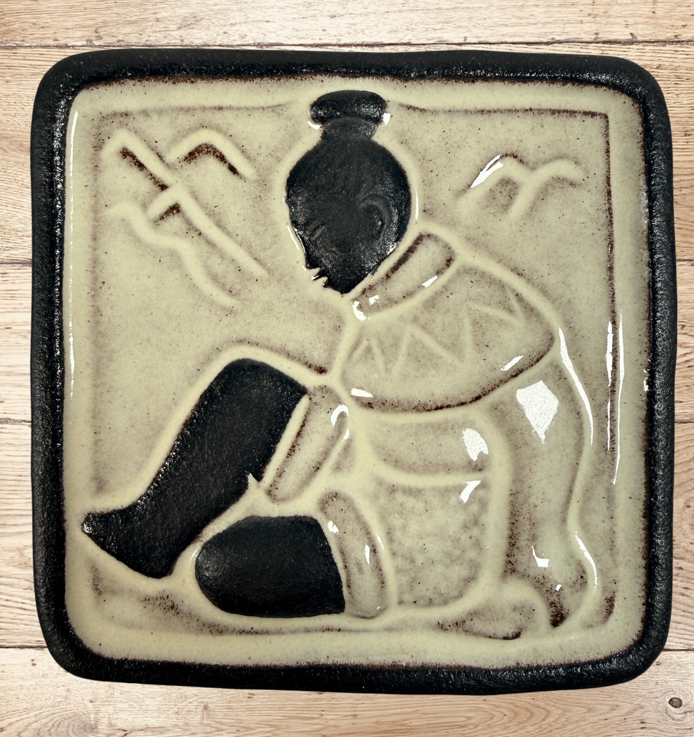 Vintage Hyllested Keramik Denmark wall plaque in Adam Zwior style featuring Inuit relief art and Scandinavian chamotte stoneware design.