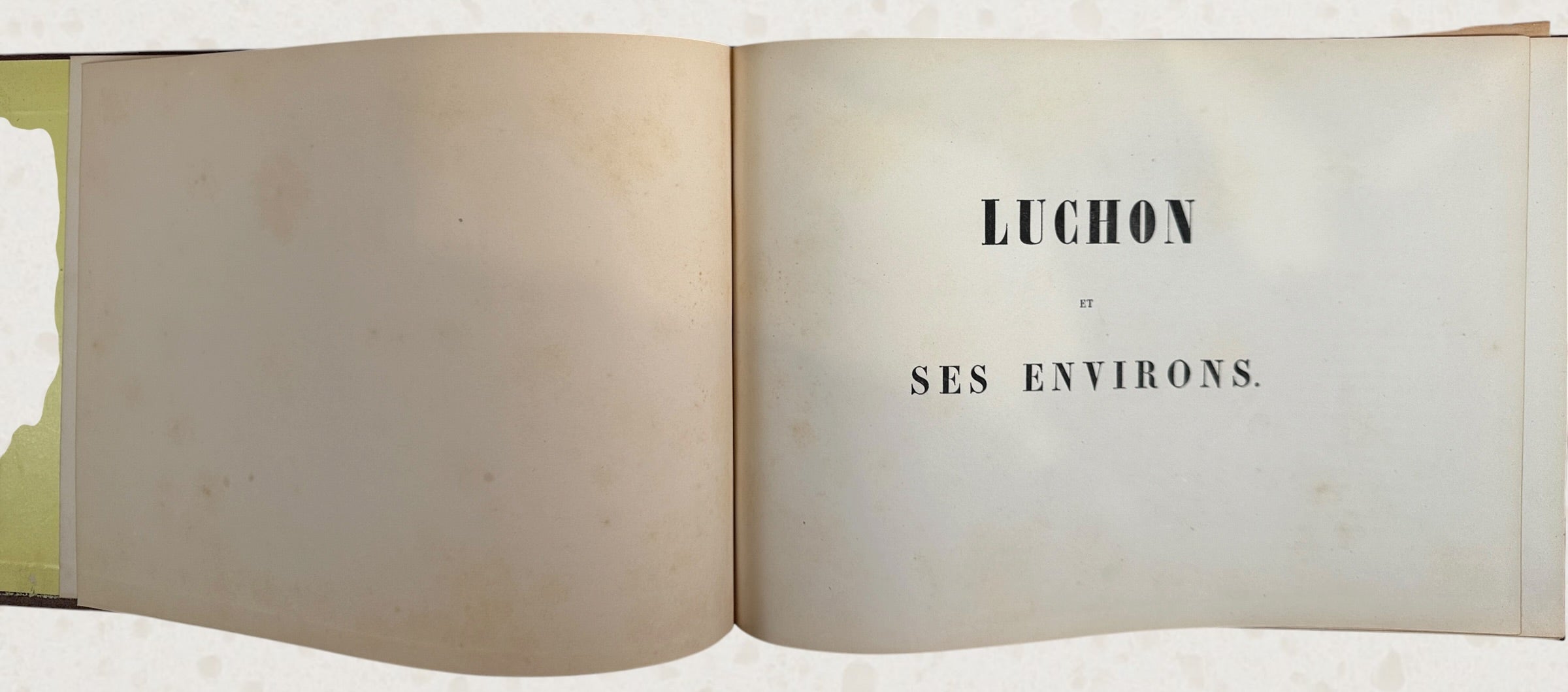 Antique French lithograph album featuring scenic Pyrenees views of Luchon, original 19th-century plates, fold-outs, and gilt decorative binding.