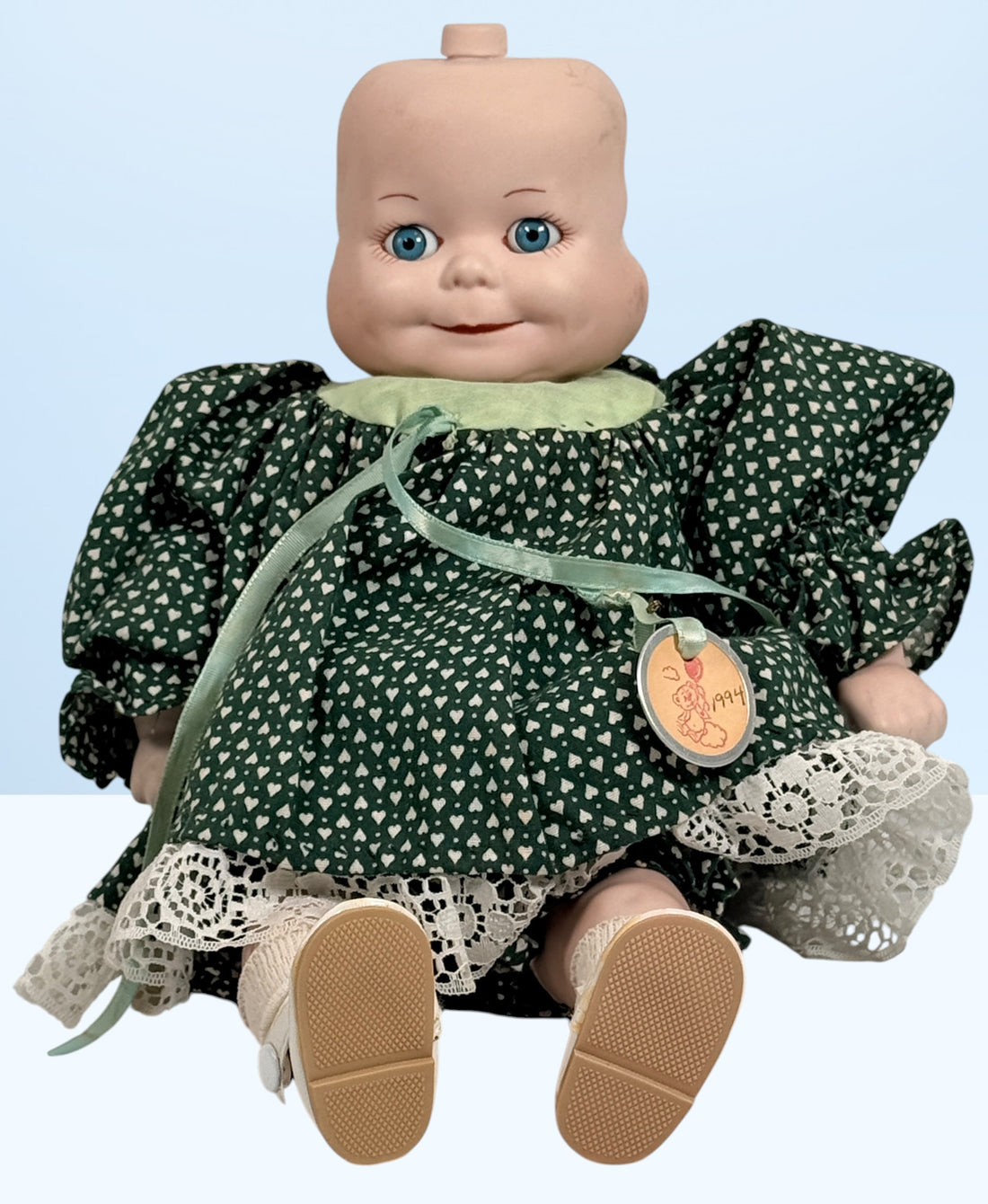 Vintage 1994 three-face baby doll with rotating expressions, lace dress, and novelty design. Rare collectible doll for vintage toy and decor collectors.